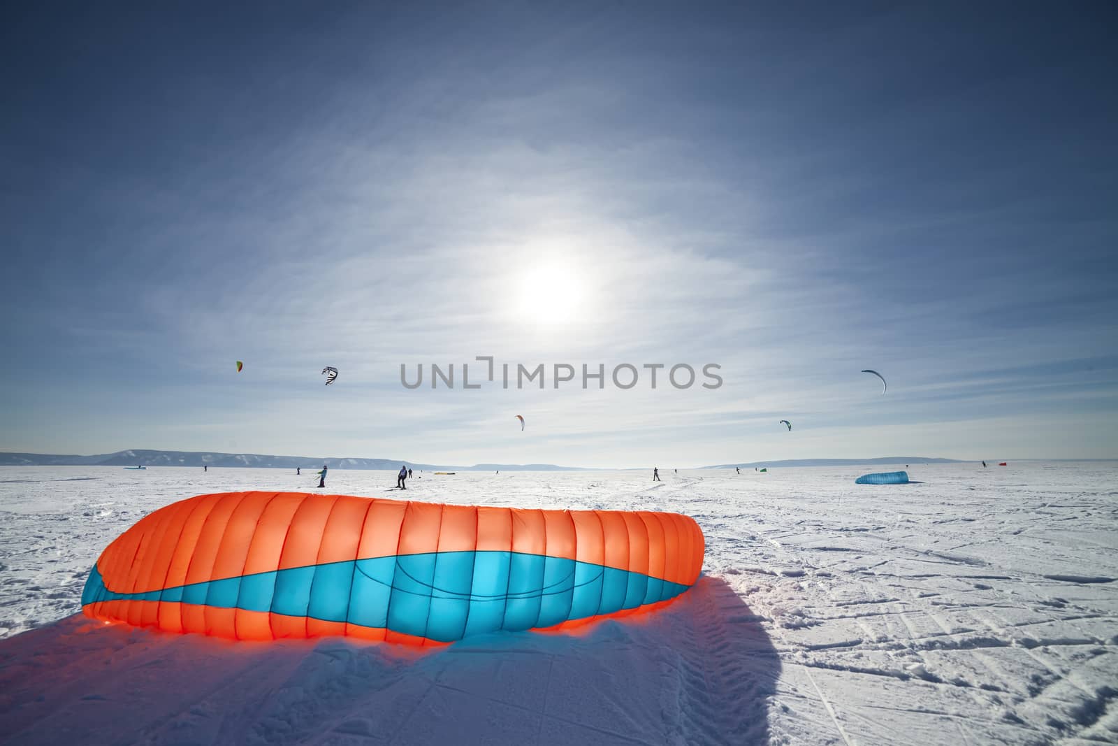 Kiteboarder with blue kite on the snow by H2Oshka