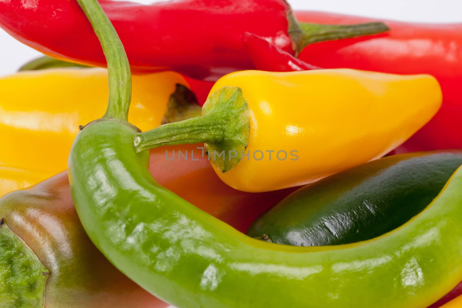heap of colorful raw chili pepper isolated on white background