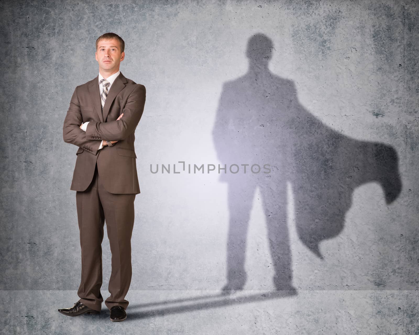 Businessman with shadow in cape by cherezoff