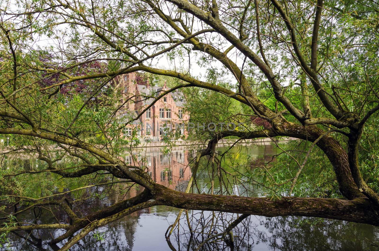 Flemish style building in Minnewater lake, Fairytale scenery in Bruges, Belgium