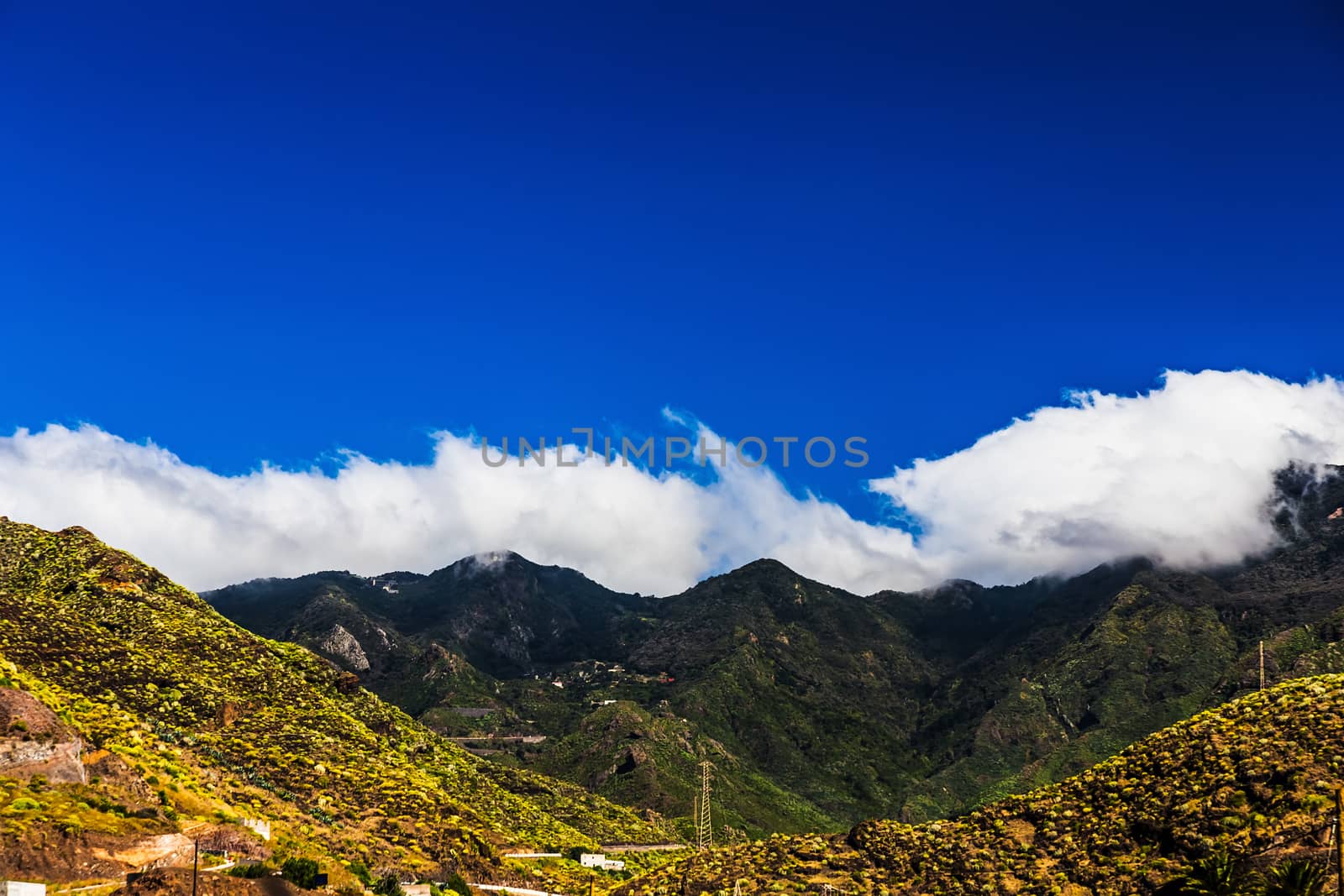 Mountain and clouds on blue sky background