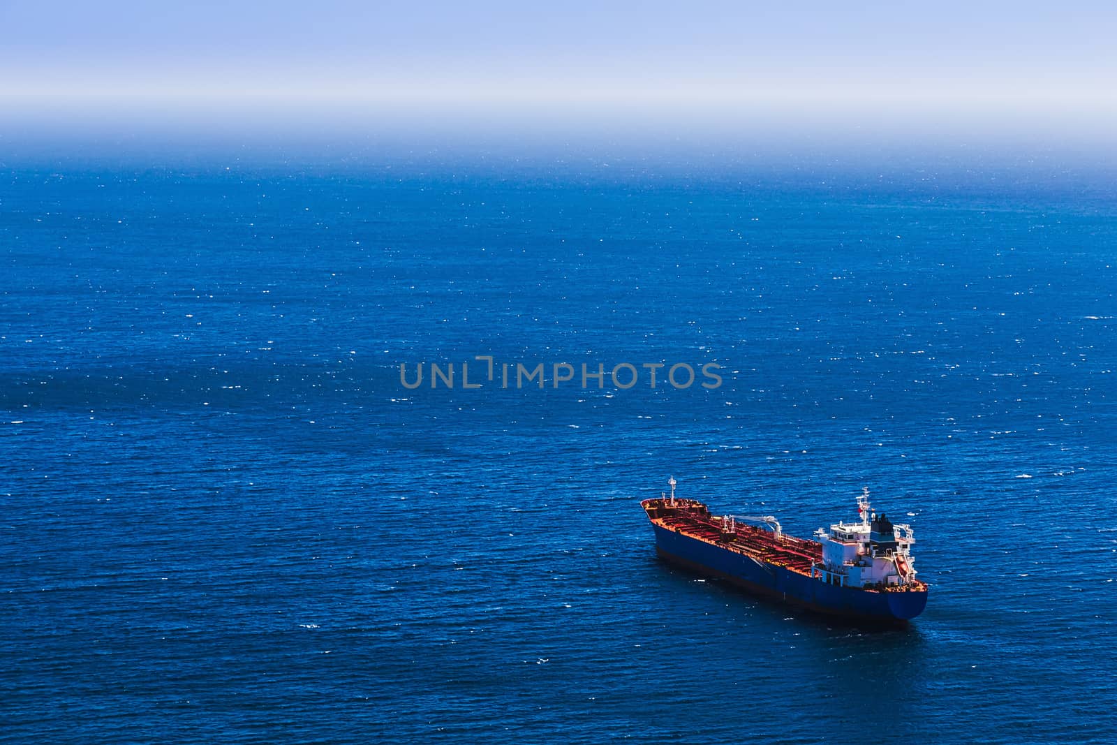 Aerial view to empty container cargo ship in the blue ocean