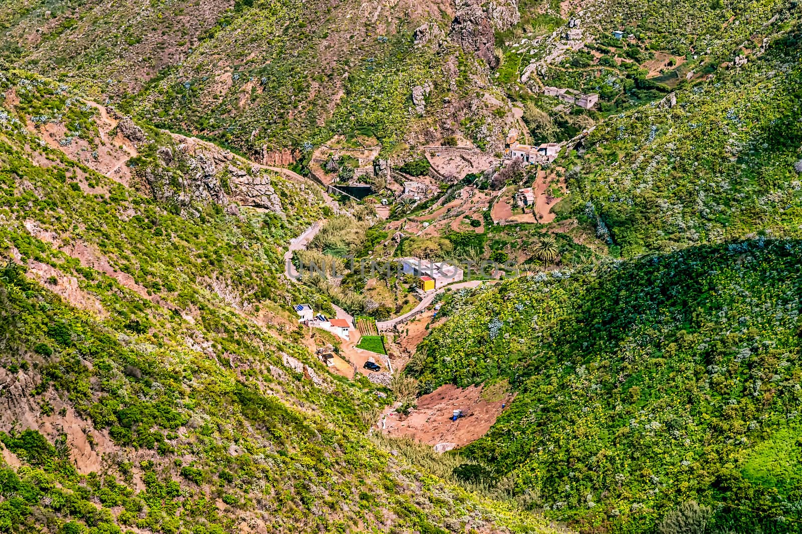 Small buildings in green mountains valley on Tenerife Canary island, Spain