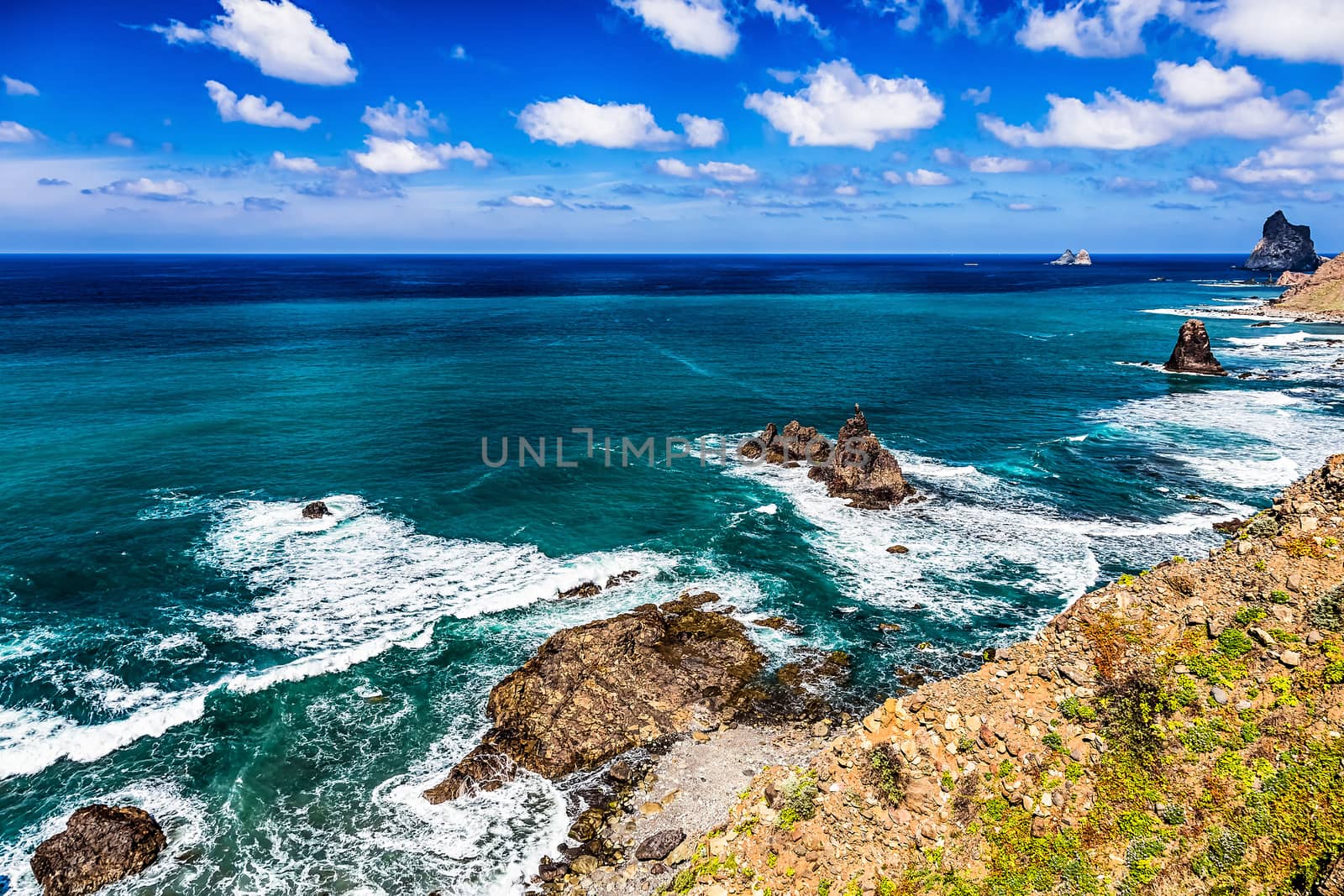 Coast or shore of Atlantic ocean with  mountain or rock and blue sky with clouds and skyline in Tenerife Canary island, Spain at spring or summer