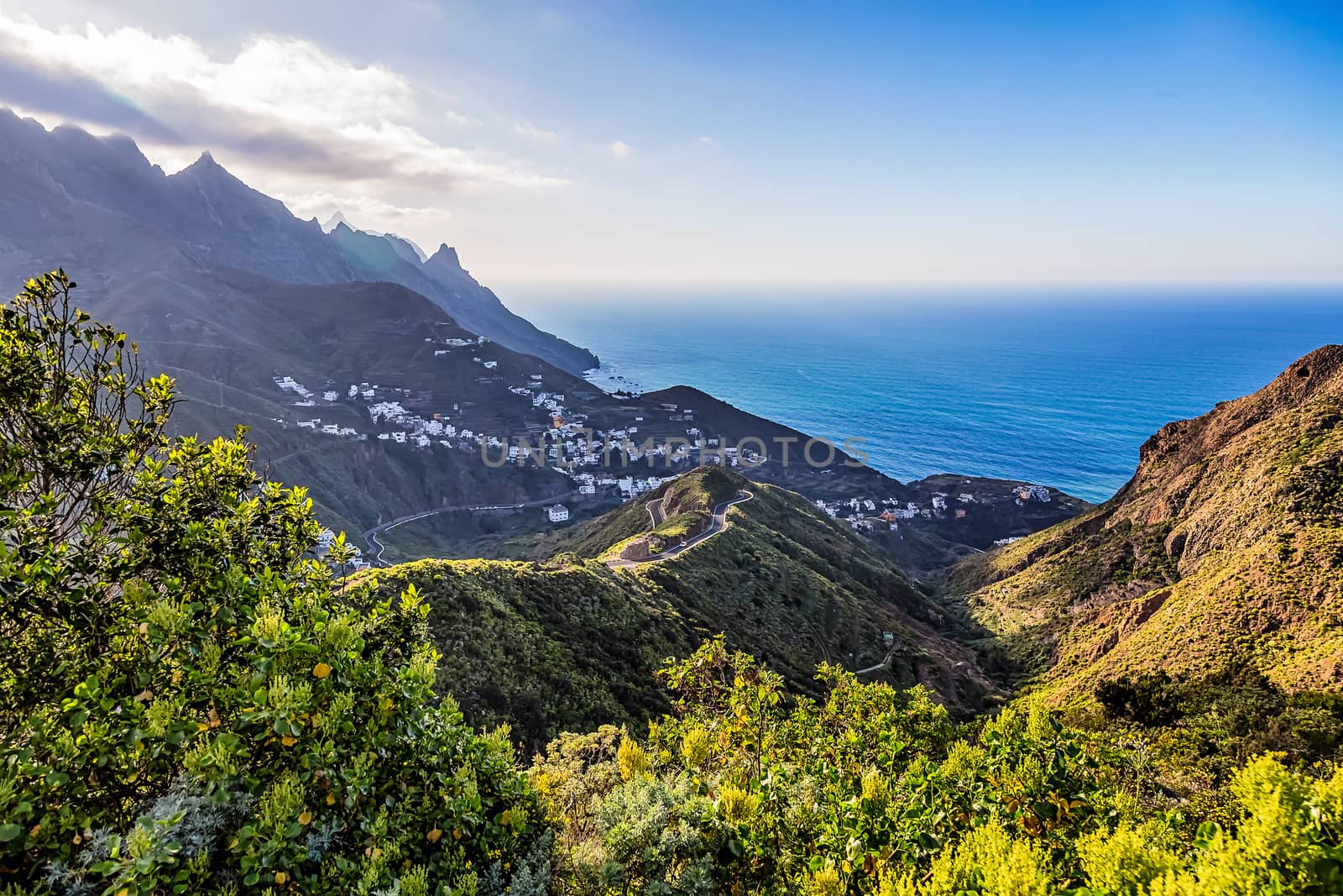 Small village in mountains with clouds landscape near the coast or shore of Atlantic ocean in Tenerife Canary island, Spain