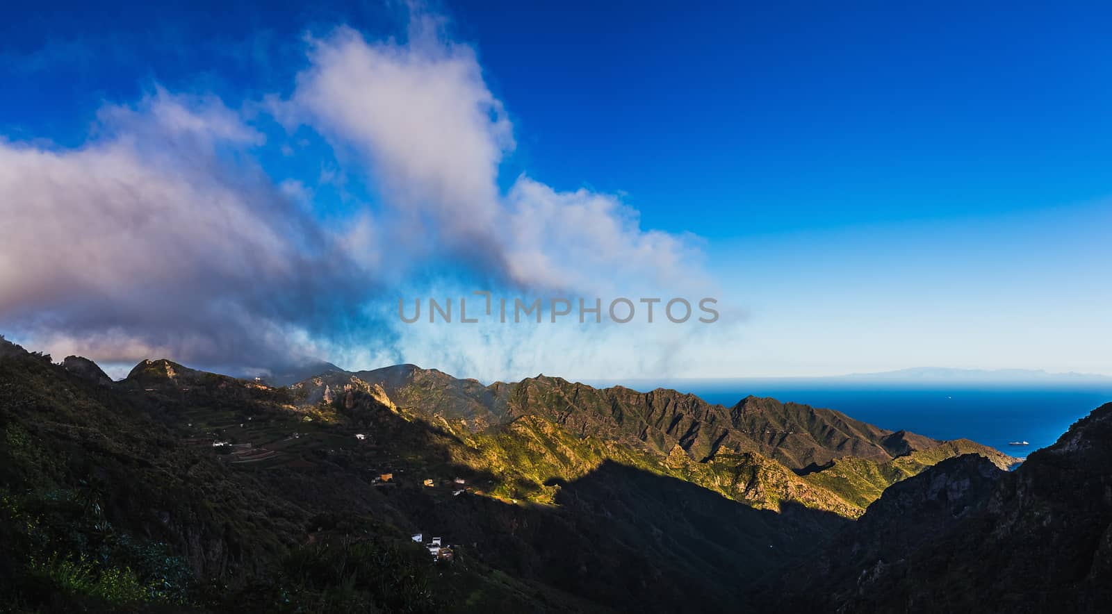 Clouds and mountains or rocks with blue sky horizon background near the Atlantic ocean landscape in Tenerife Canary island, Spain