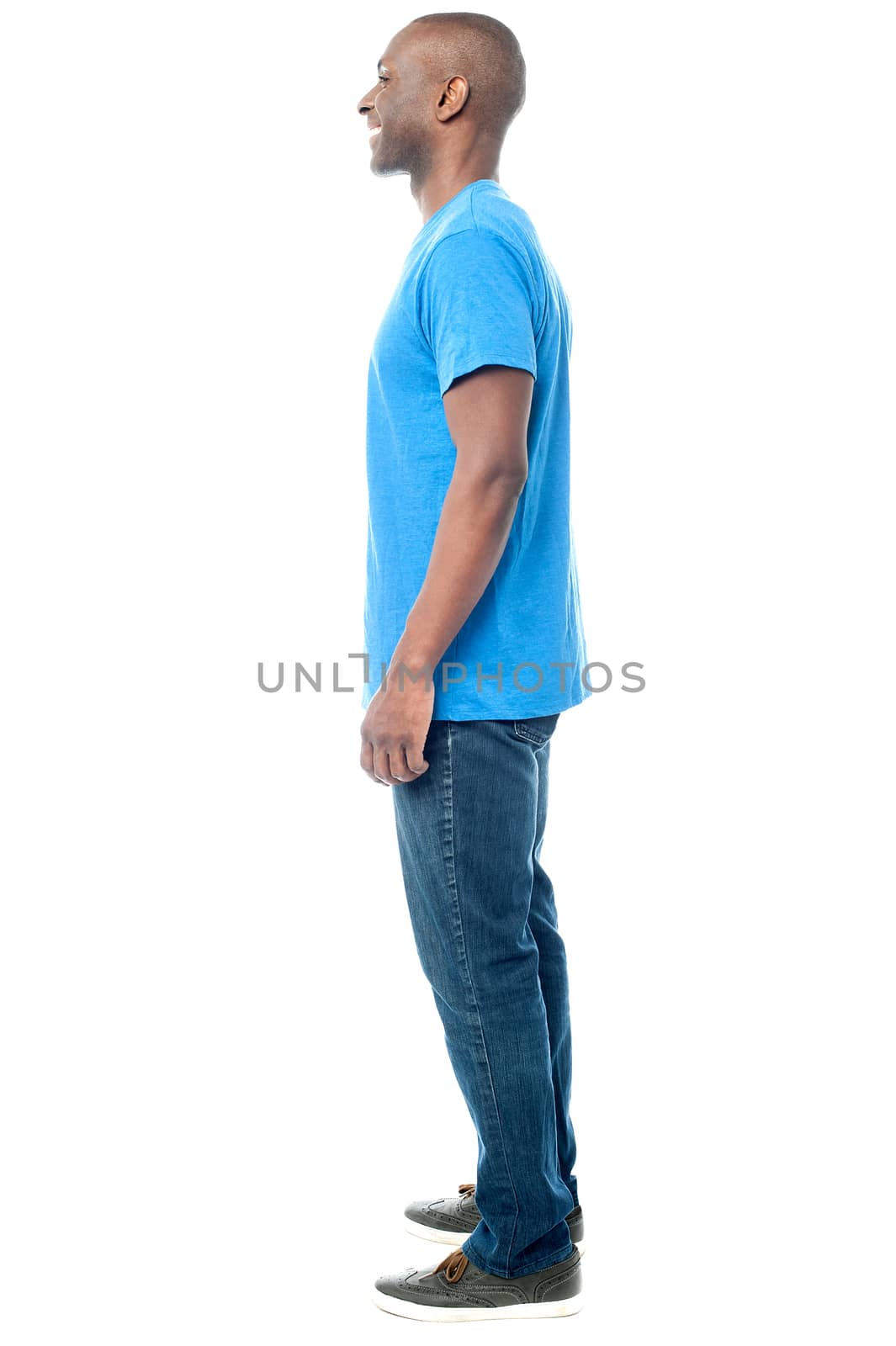 Full length of casual man posing sideways