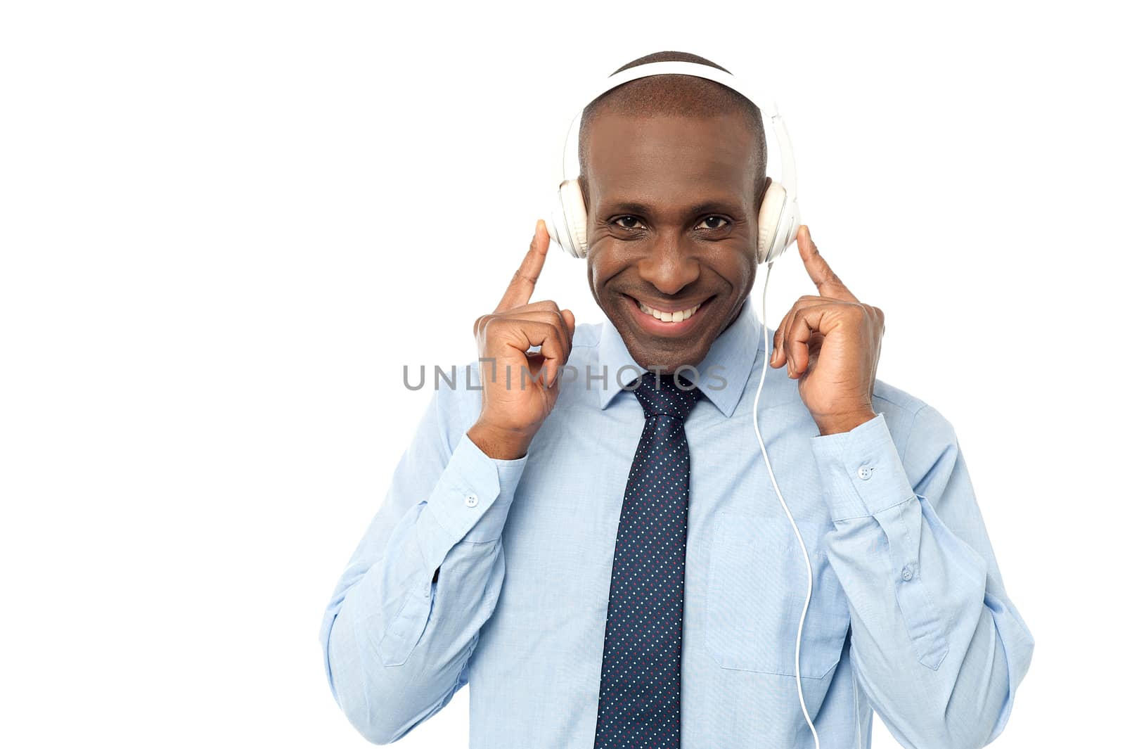Happy male executive enjoying songs with earphones