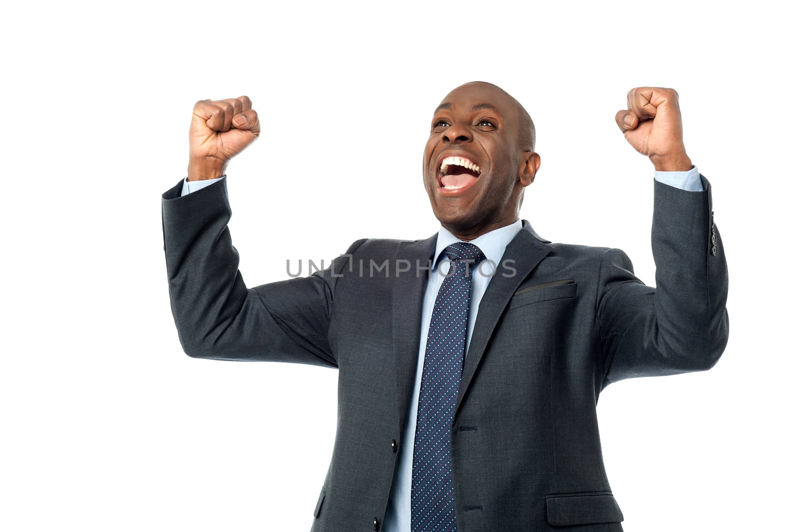 Successful male entrepreneur clenching his fists over white