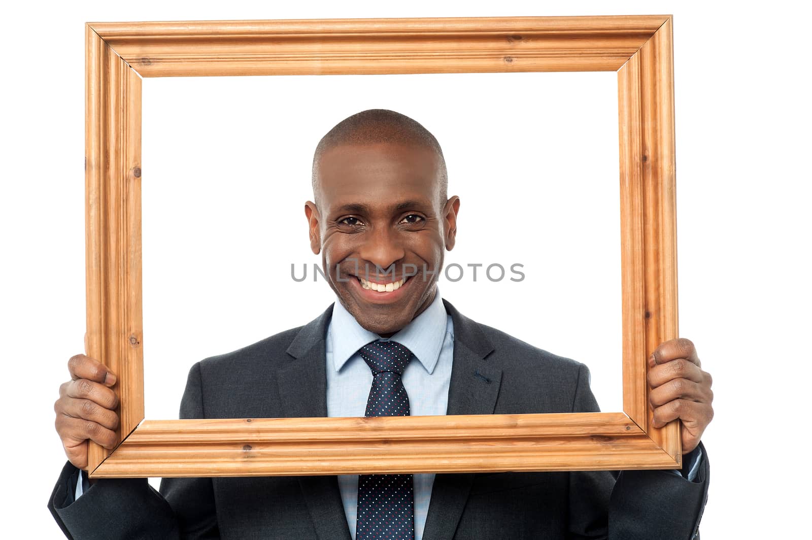 Smiling businessman looking through picture frame over white