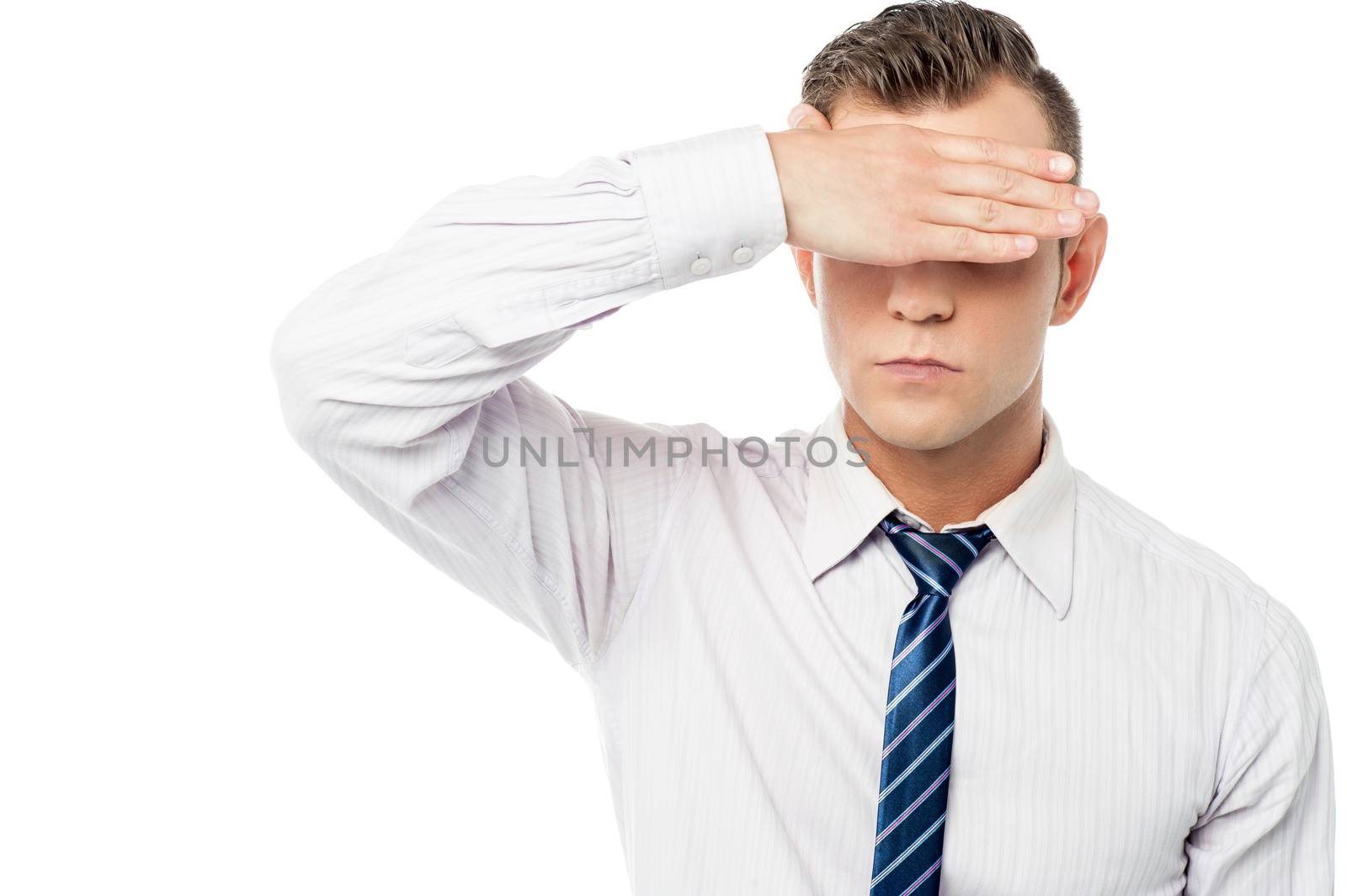 Male executive covering eyes with his hand