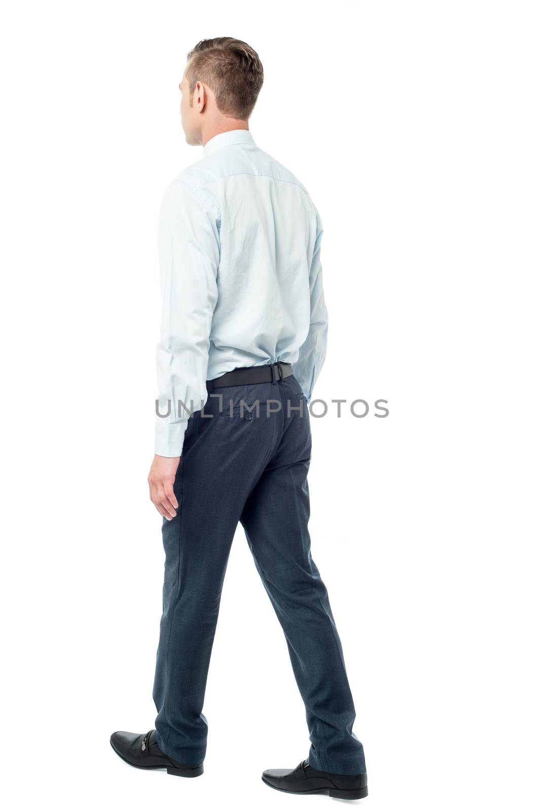 Back view of walking businessman by stockyimages