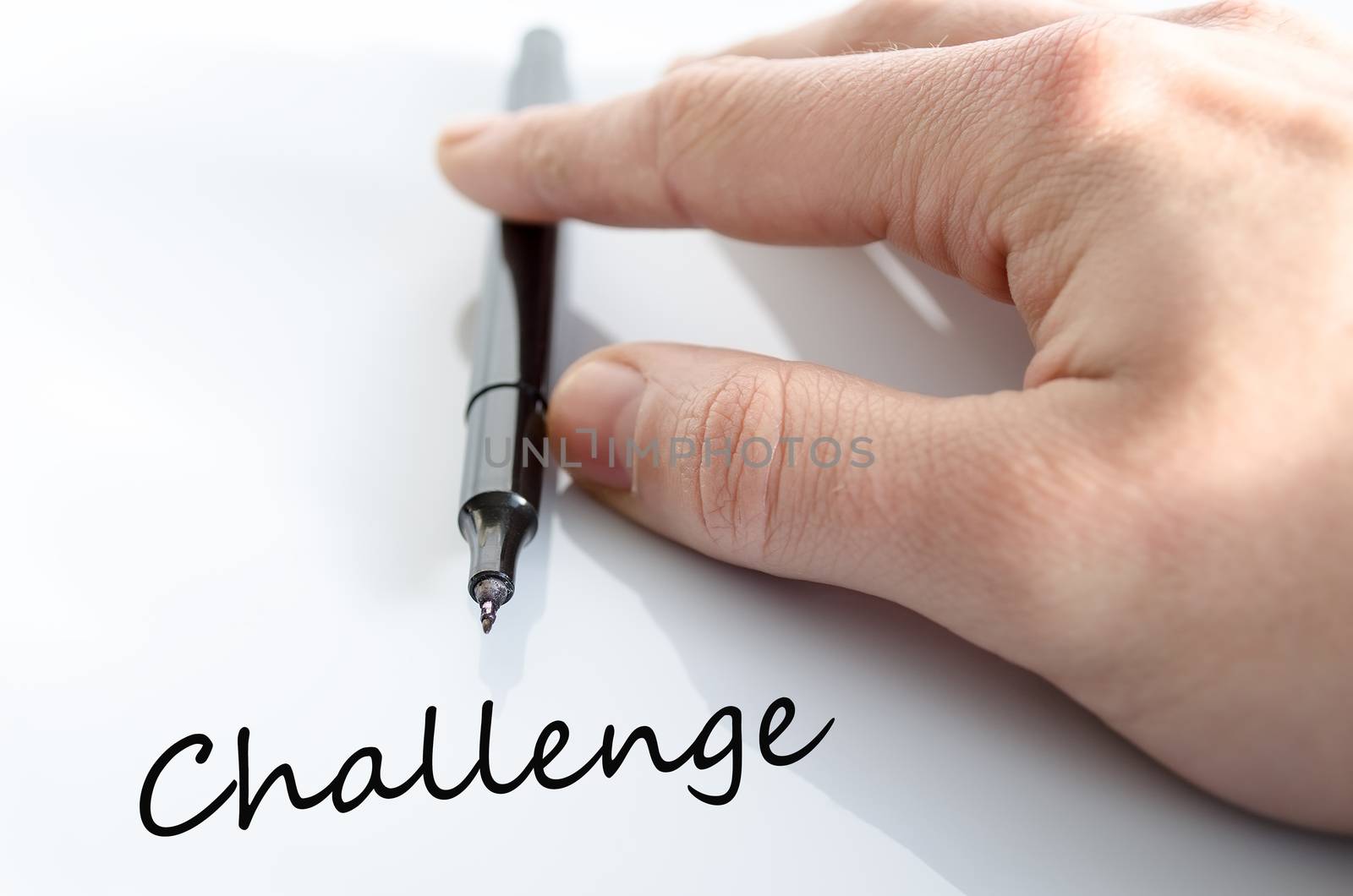 Pen in the hand isolated over white background Challenge Concept