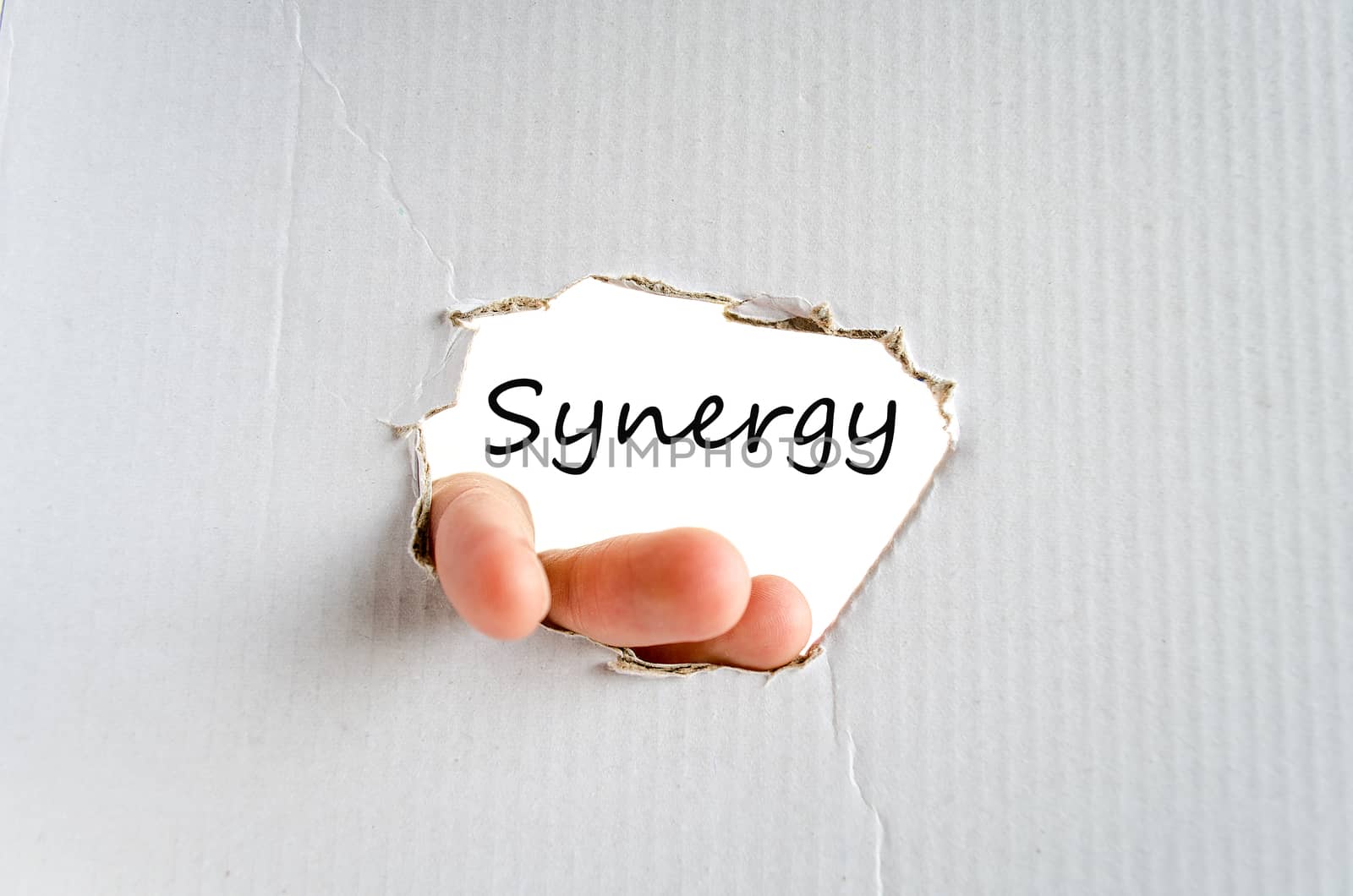 Hand and text on the cardboard background Synergy