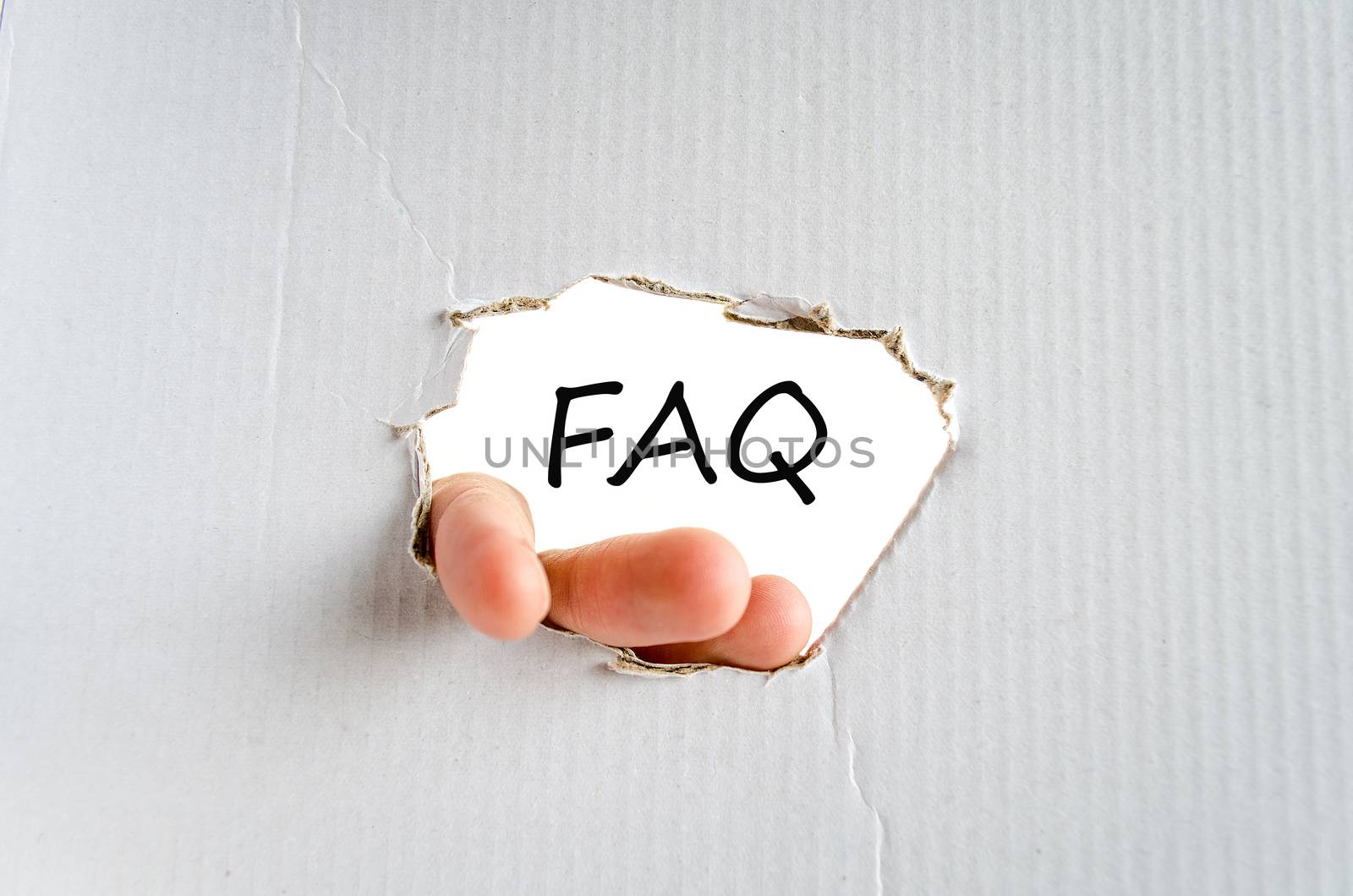 Hand and text on the cardboard background Faq Concept