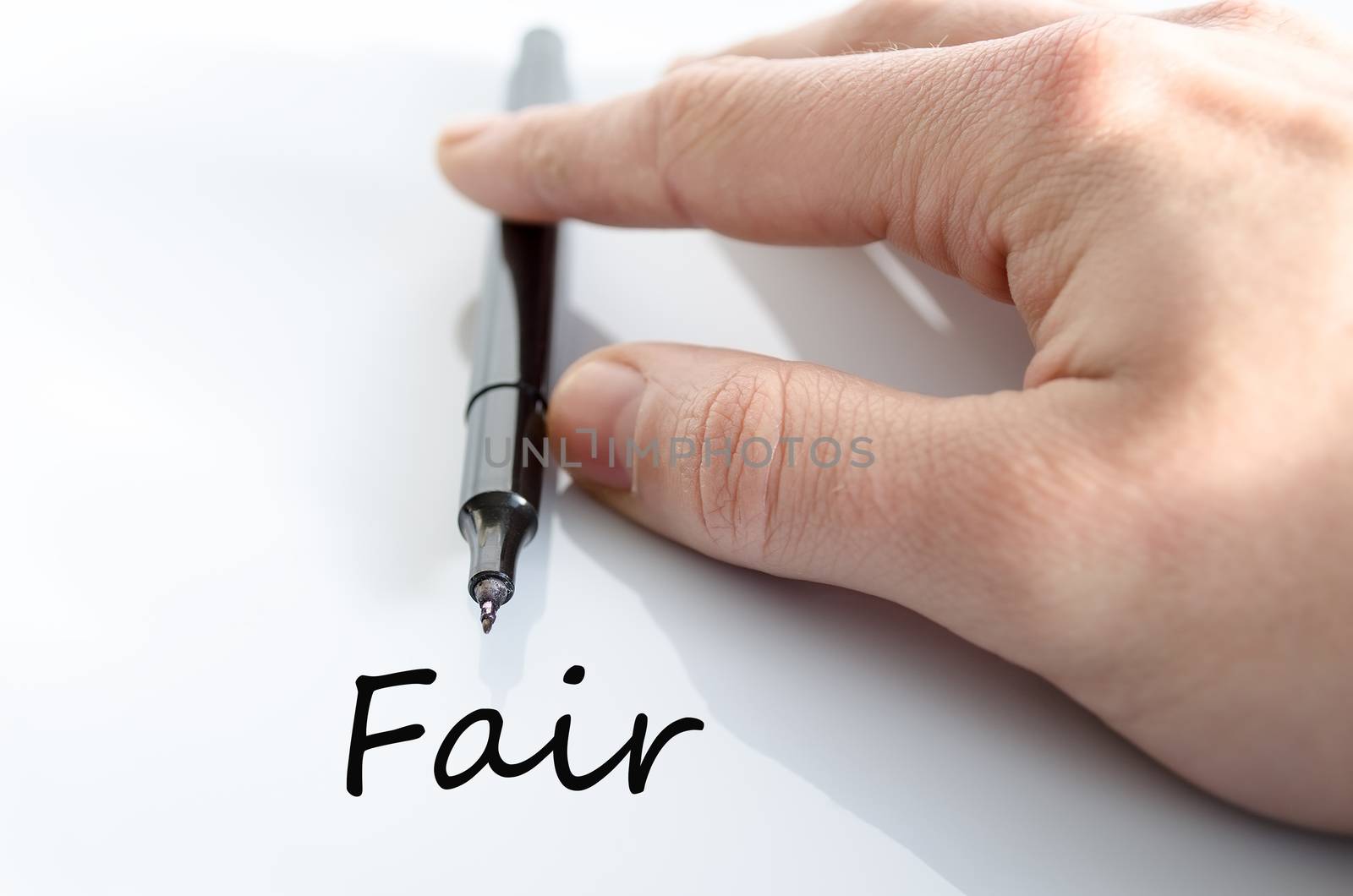 Pen in the hand isolated over white background Fair