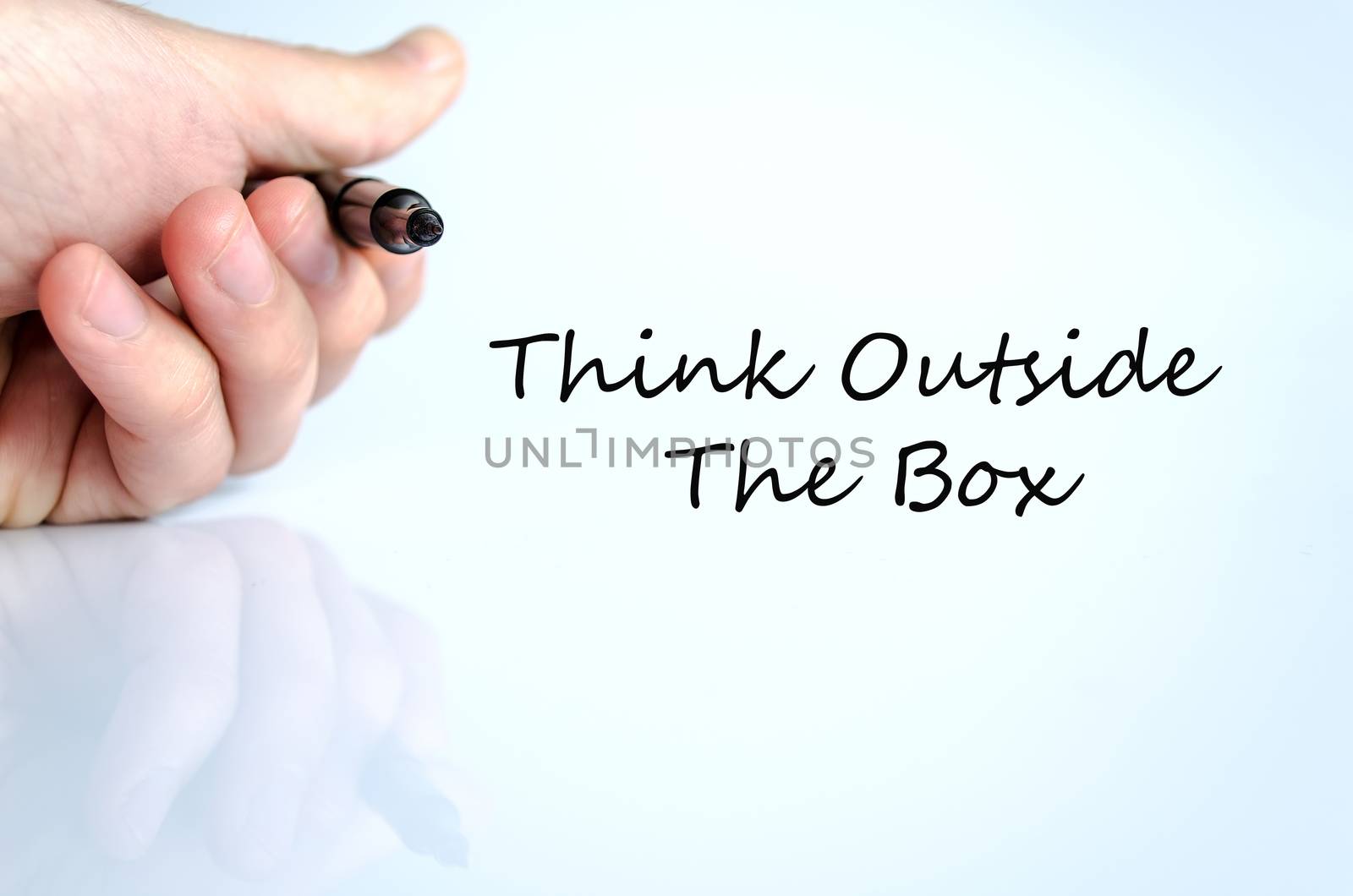Pen in the hand isolated over white background Think outside the box concept