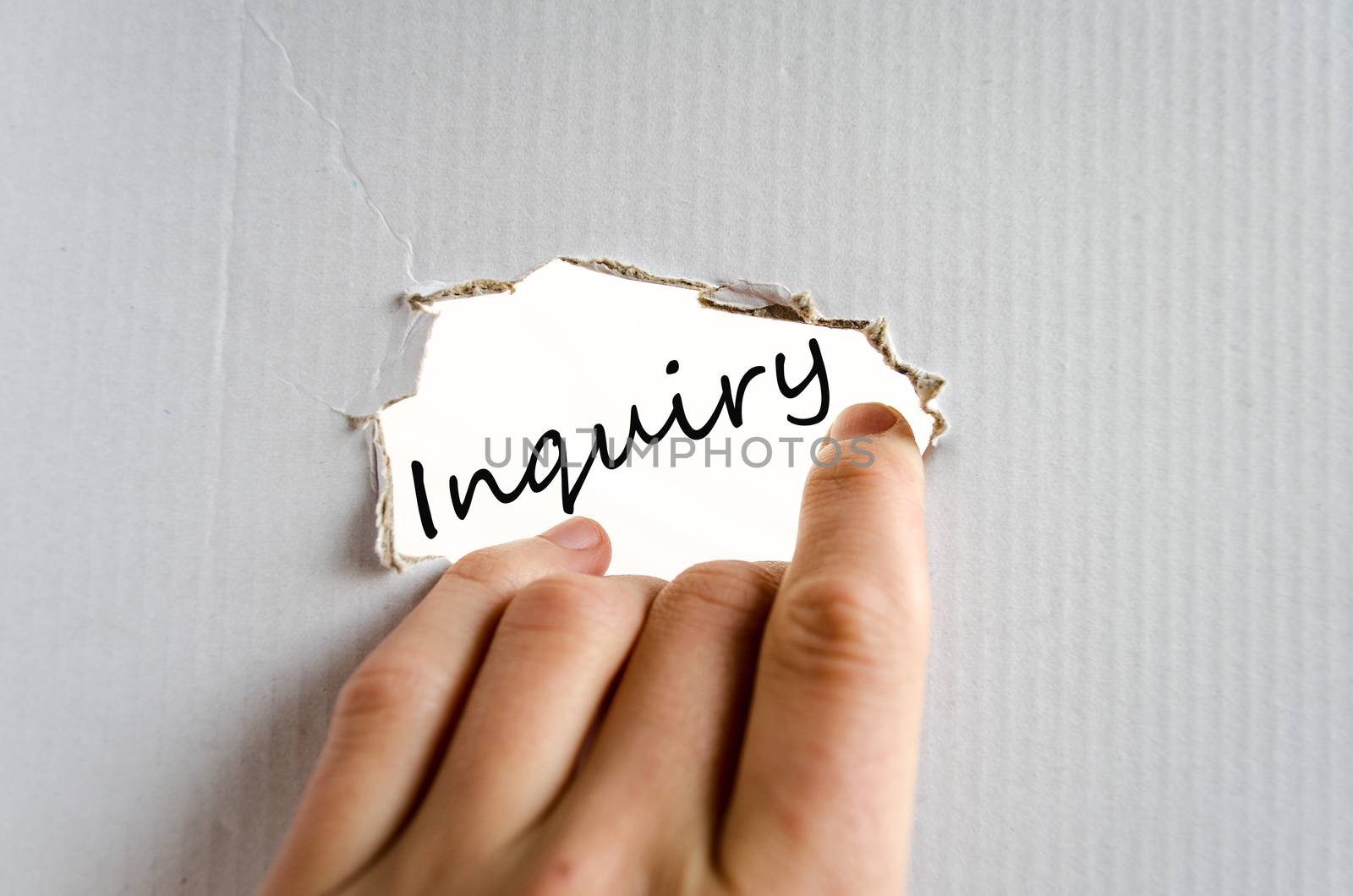 Hand and text on the cardboard background Inquiry