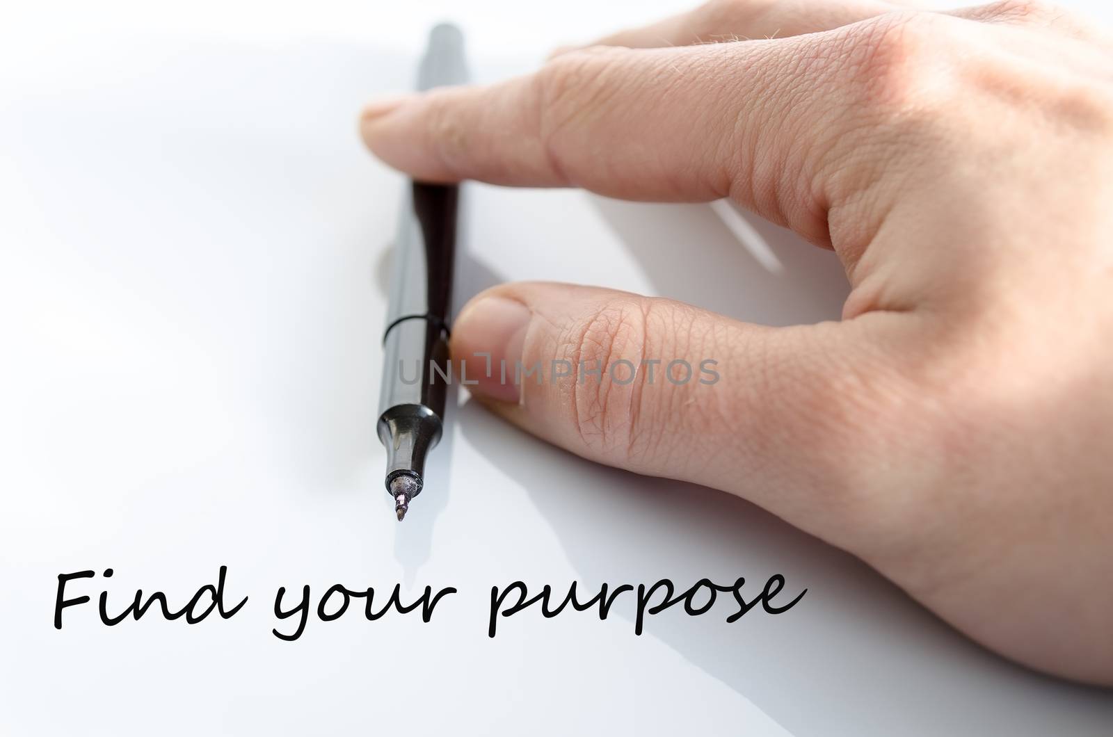 Pen in the hand isolated over white background Find your purpose concept