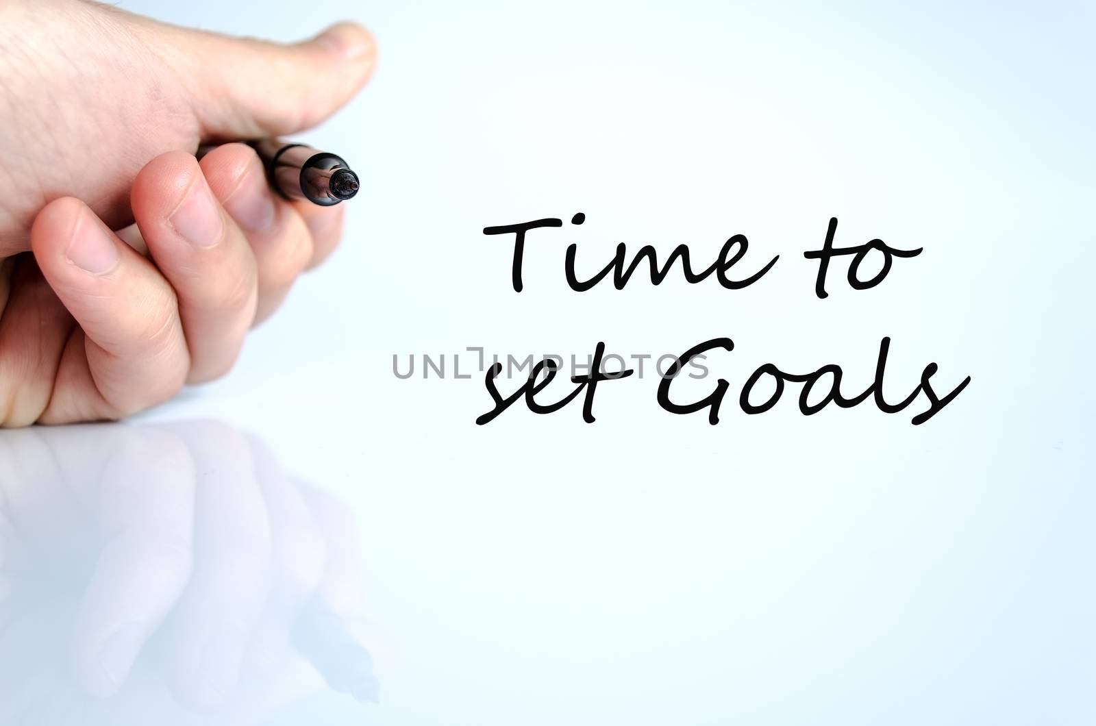 Pen in the hand isolated over white background Time to set goals concept
