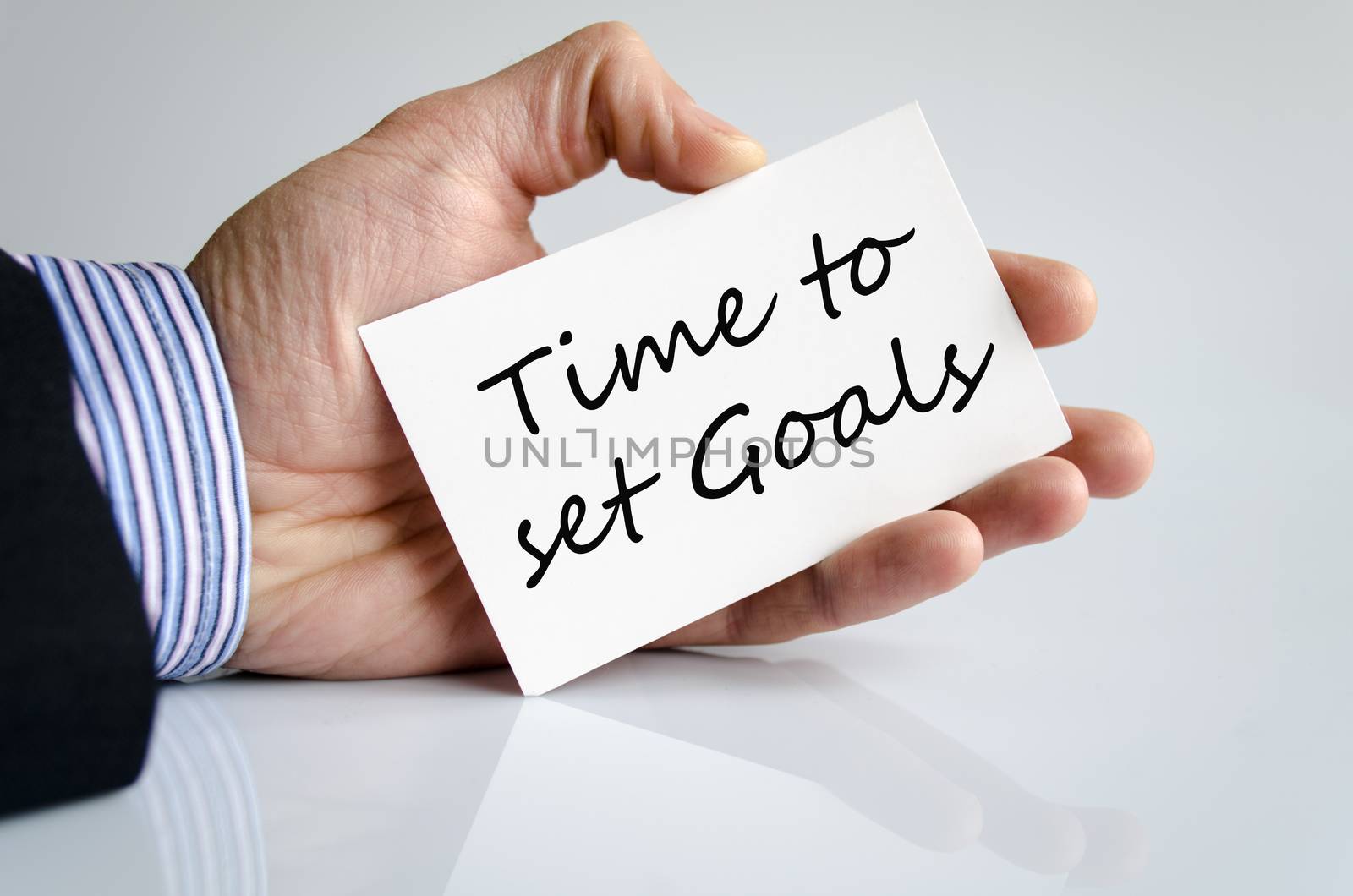 Business man hand writing Time to set goals