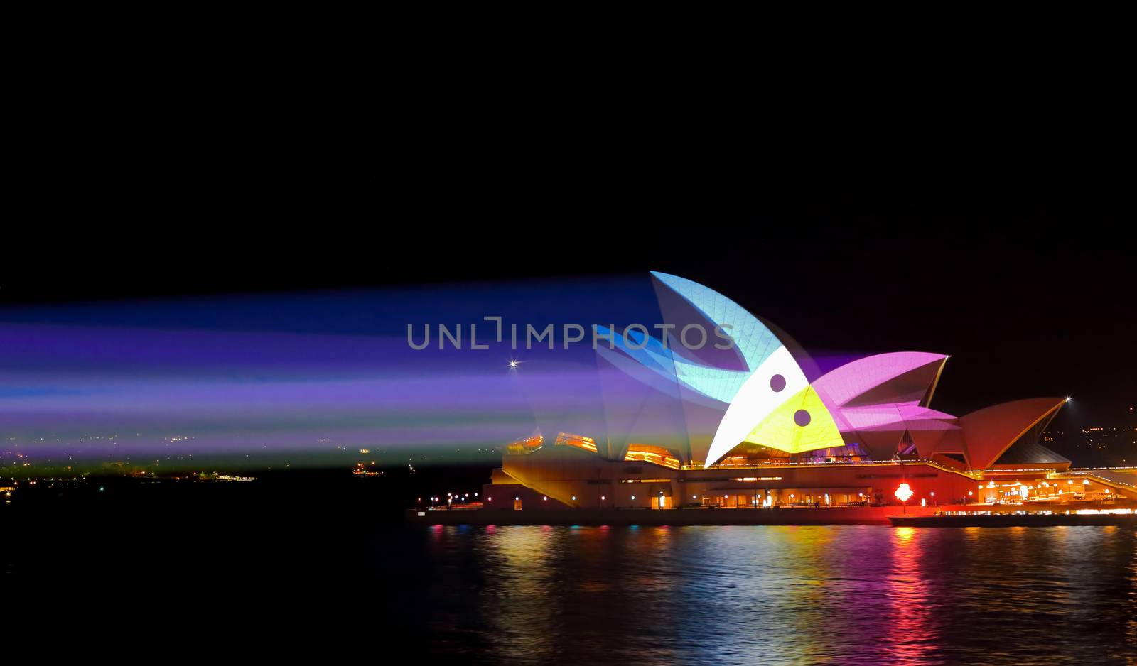SYDNEY, AUSTRALIA - MAY 25, 2015;   Light beams stream onto the iconic landmark, the Sydney Opera House casting various moving patterns andn imagery during Vivid Sydney annual festival event. Bird like image shown.  Super high ISO to freeze the pattern