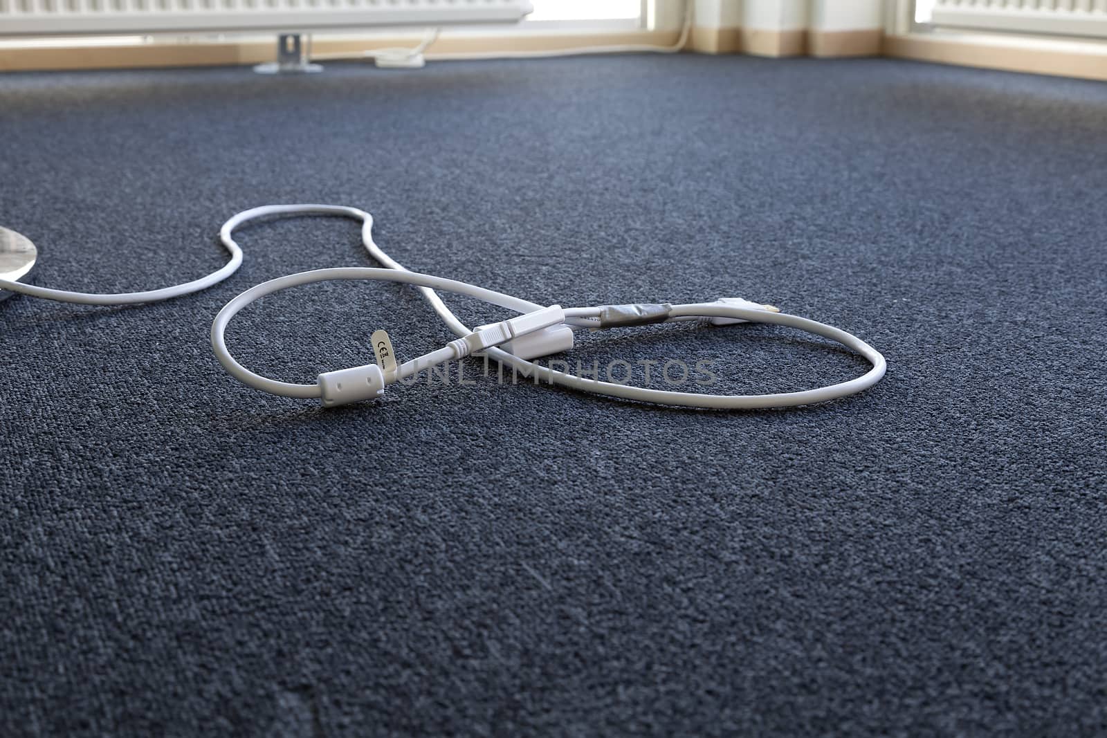 A cable laying on the floor in an office