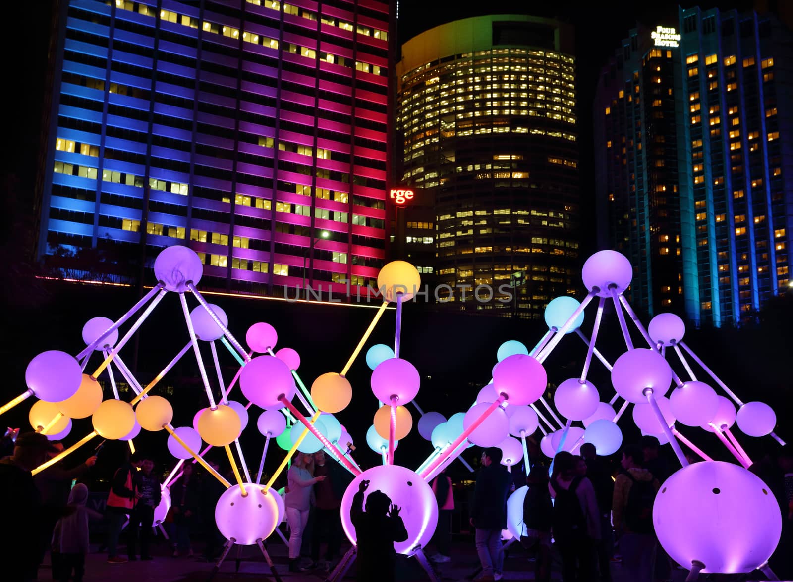 SYDNEY, AUSTRALIA, MAY 25, 2015:  Tourists and local public enjoy the Affinity installation at Vivid Sydney, which  depict the dazzling complexity and connectivity of the human brain and neurons.  When stimulated by touch, the orbs set-up a striking display of sound and light.  People in motion.  Artists:  amigo & amigo (Simone Chua & Renzo B. Larriviere ) + S1T2 (Chris Panzetta & Naimul Khaled)