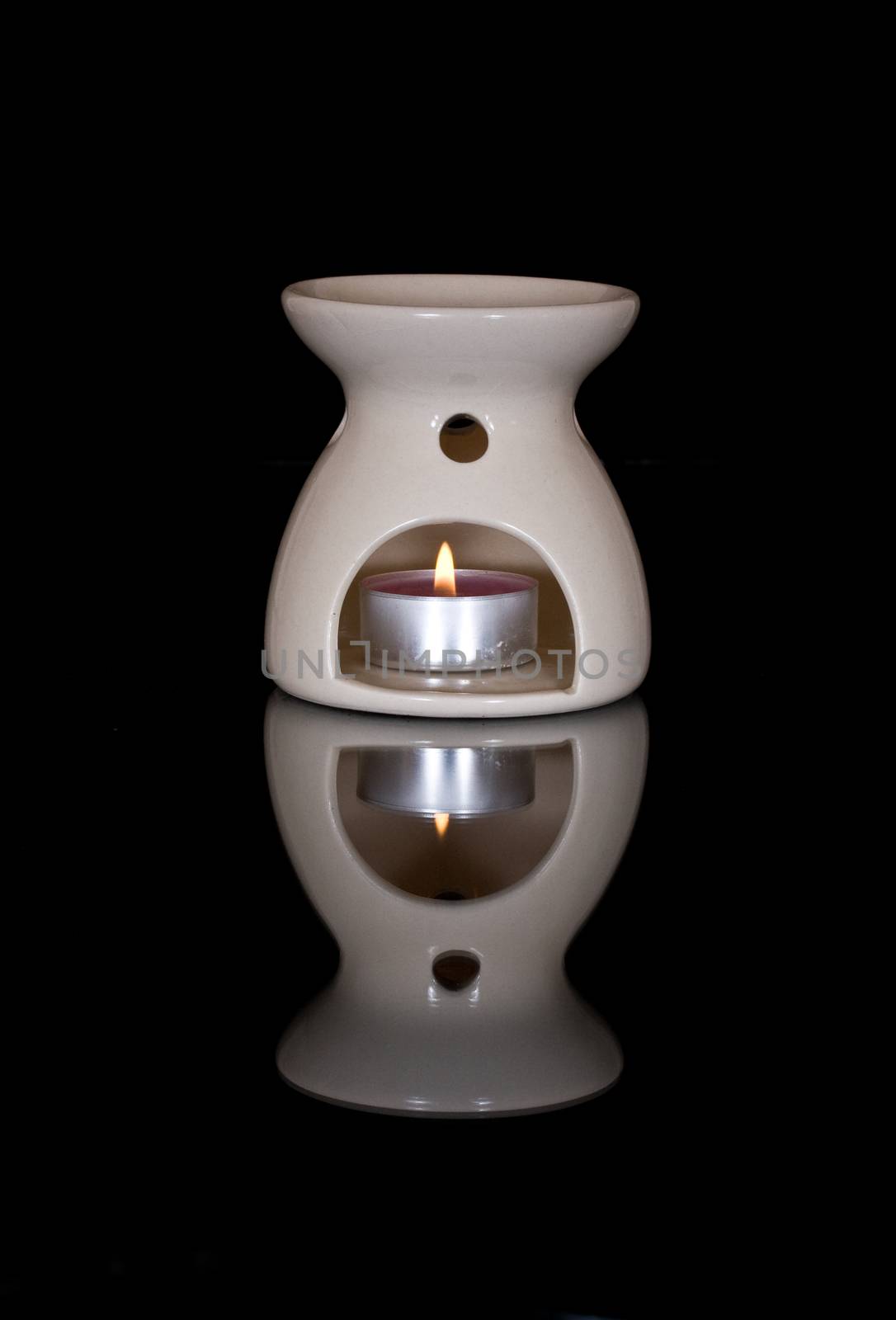 Aromatherapy Burner in the warm glow of candlelight.