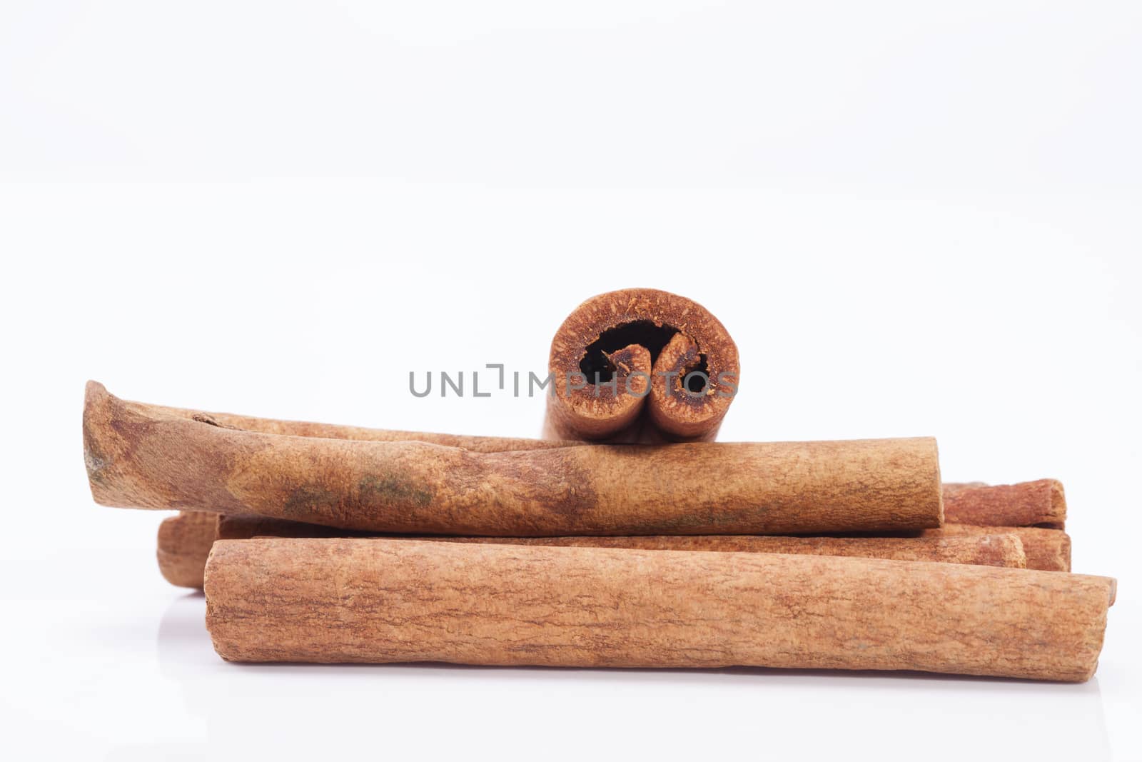 group of dried cinnamon stics isolated on white background