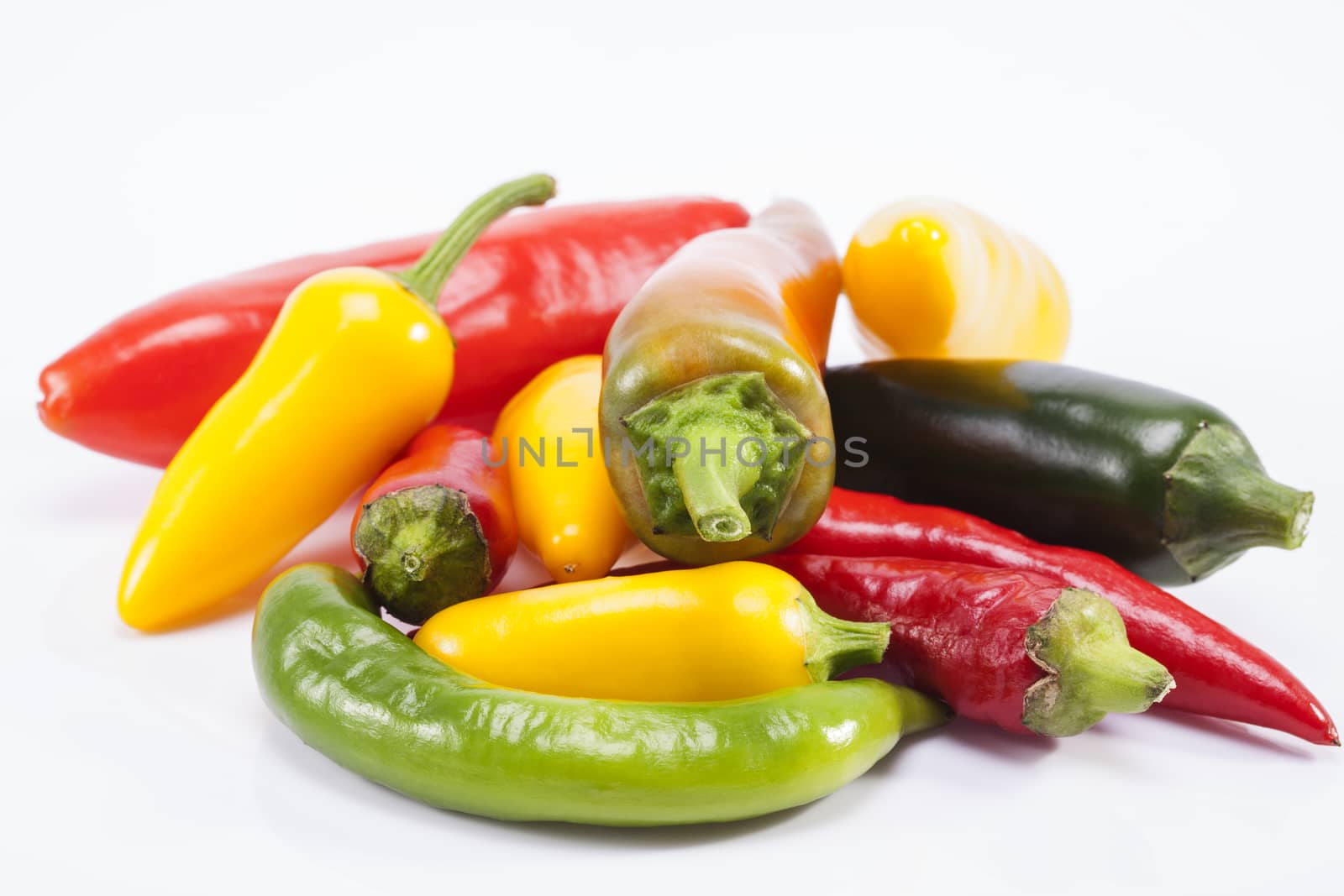 heap of colorful raw chili pepper isolated on white background