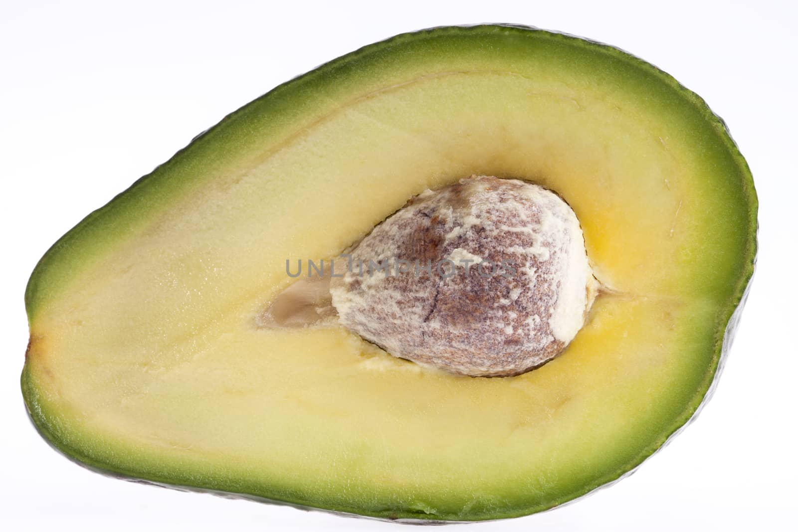 
half of cut avocado fruit with stone macro isolated on white background