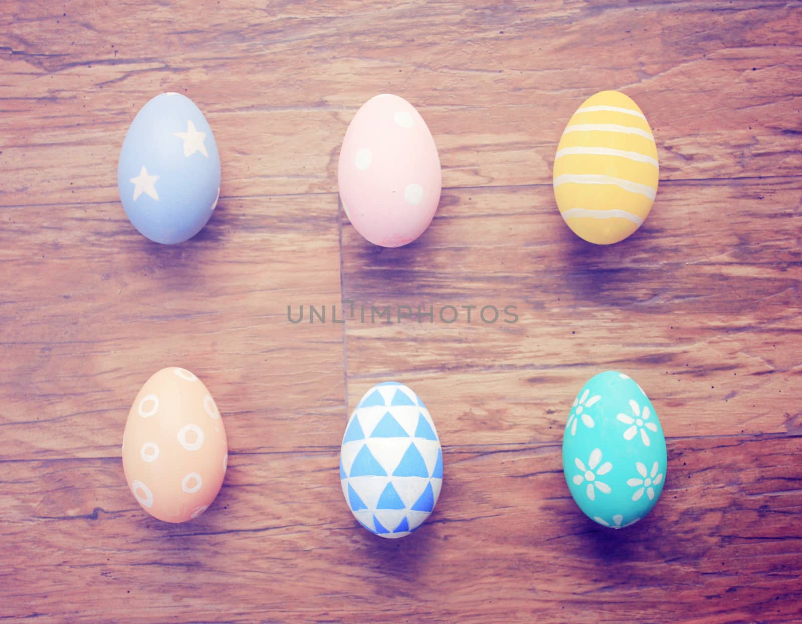 Top view of colorful easter eggs on wooden background with retro by nuchylee