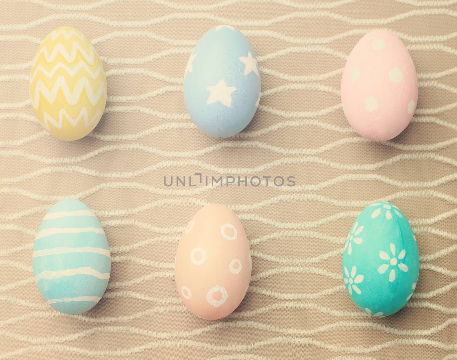 Top view of colorful easter eggs on cloth with retro filter effe by nuchylee