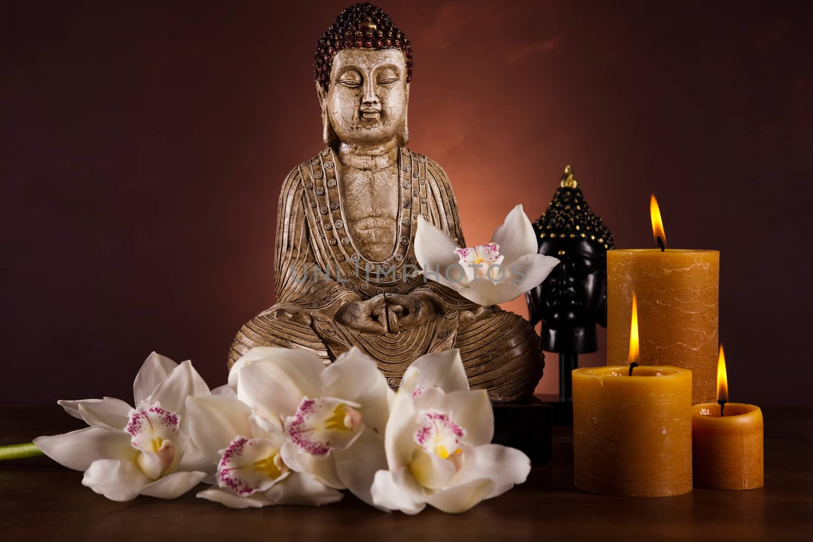 Buddha statue with orchid flower