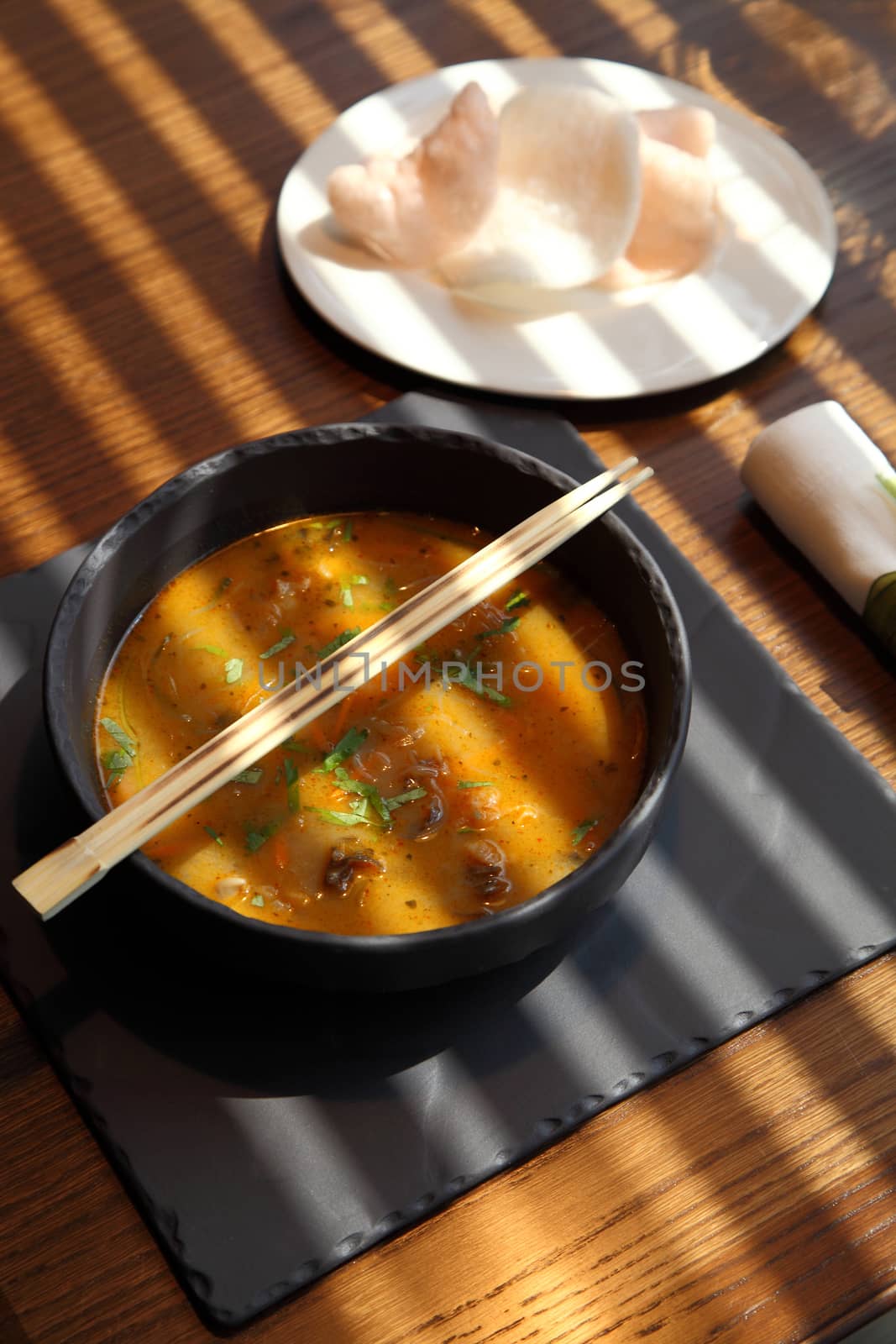 Bowl of soup and sticks on a table at Japanese restaurant