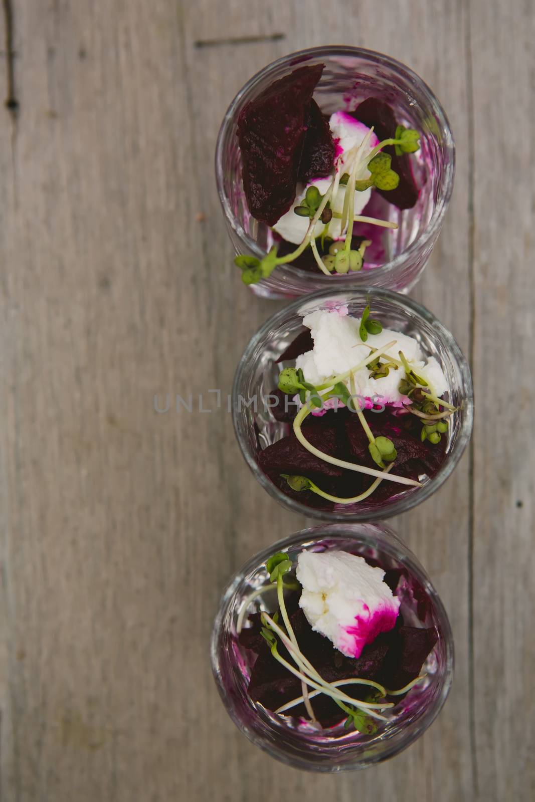 Vegetarian aperitif with beet, goat cheese and soy sprouts