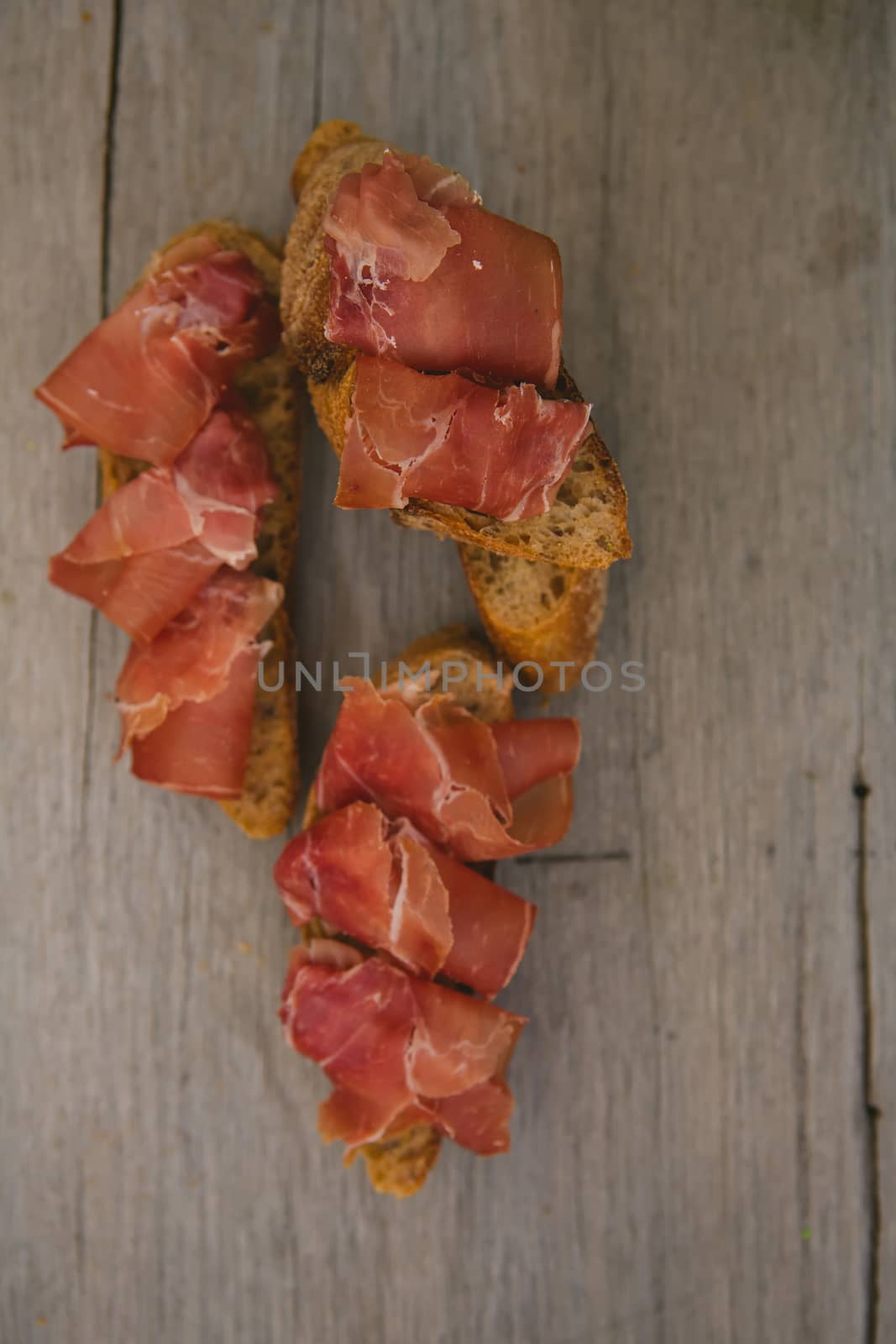 sliced prosciutto on a wooden board. Close up