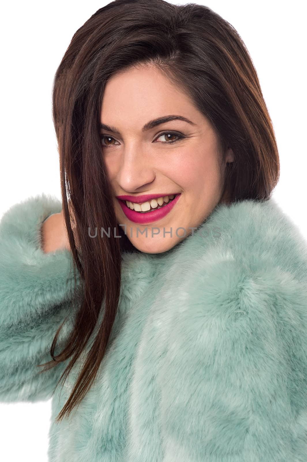 Smiling woman with fur coat.  by stockyimages