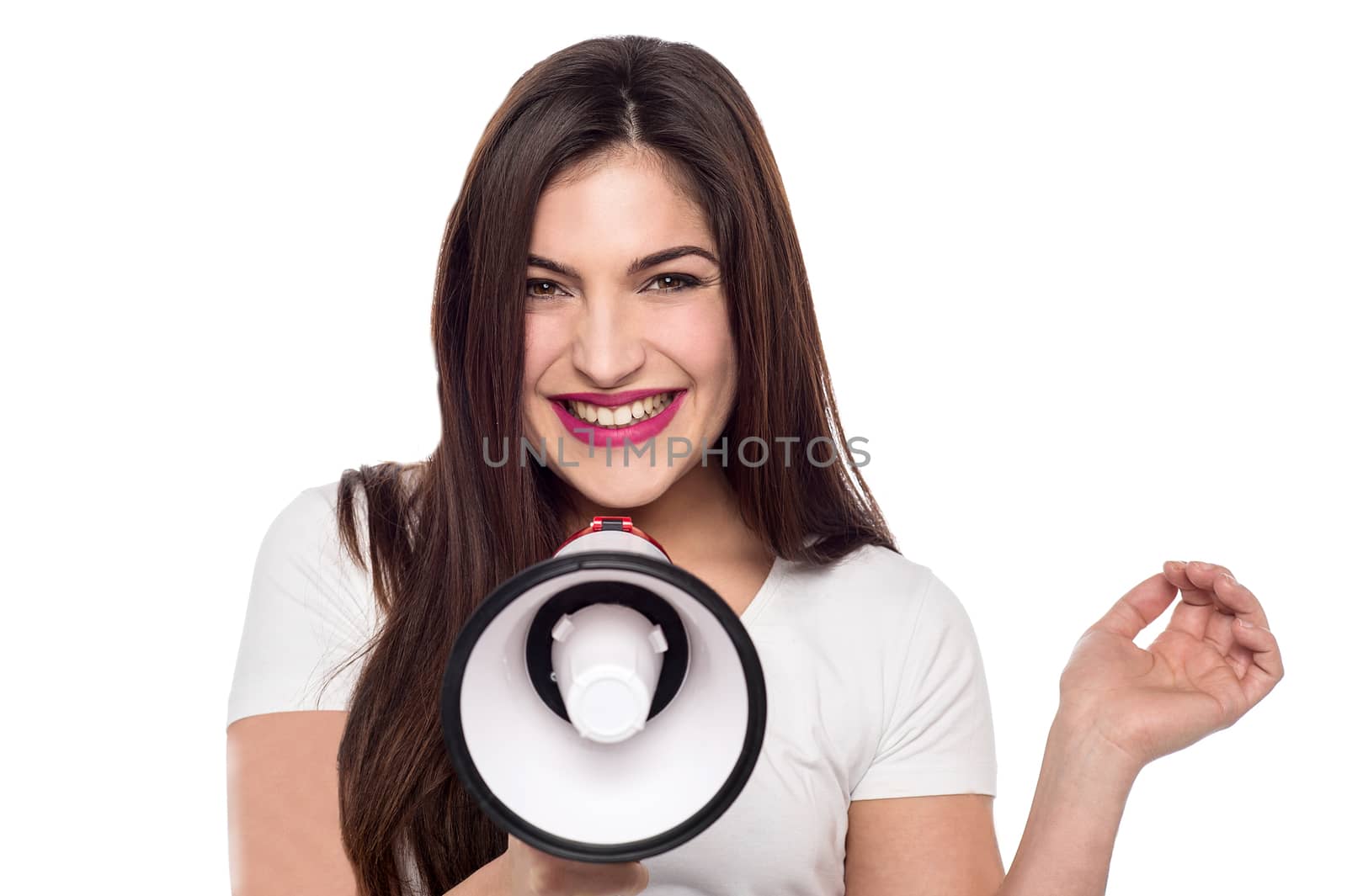 Cheerful young woman posing with loudhailer over white