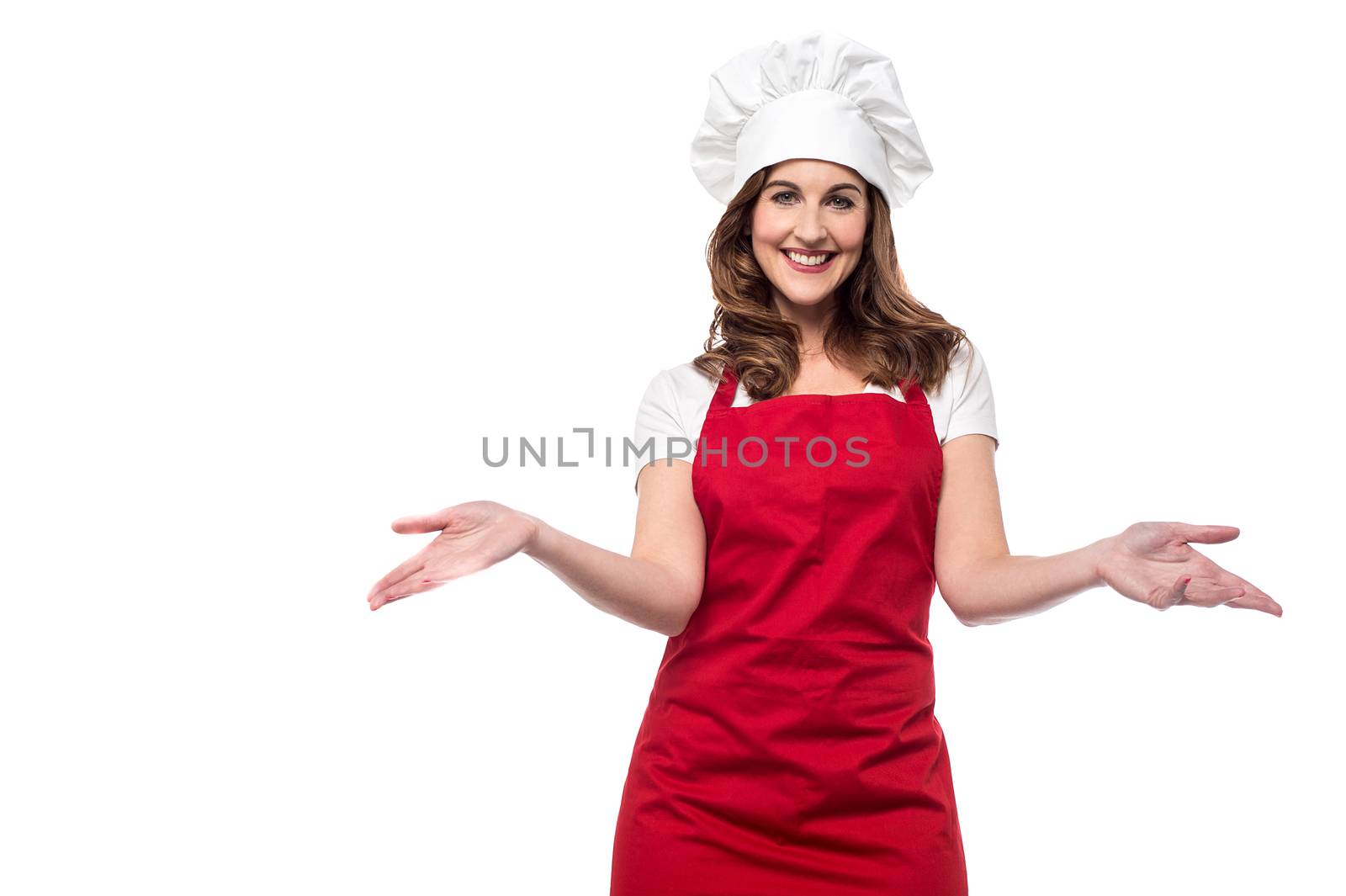 Beautiful female chef welcoming with warm smile
