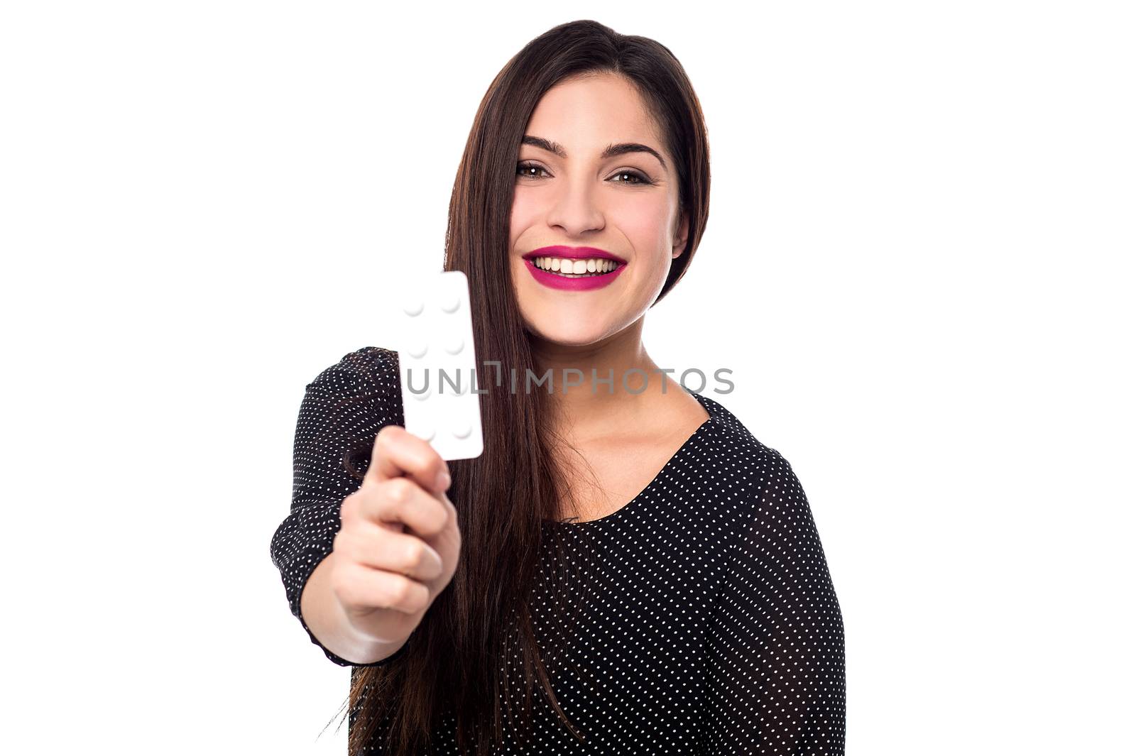 Happy young woman showing package of pills