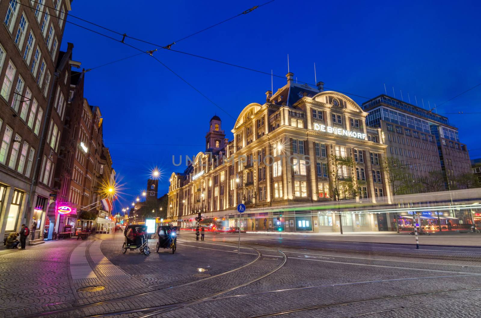 Amsterdam, Netherlands - May 7, 2015: Tourist visit De Bijenkorf store on Dam Square on May 7, 2015 in Amsterdam, Netherlands. De Bijenkorf is a chain of high-end department stores in the Netherlands.