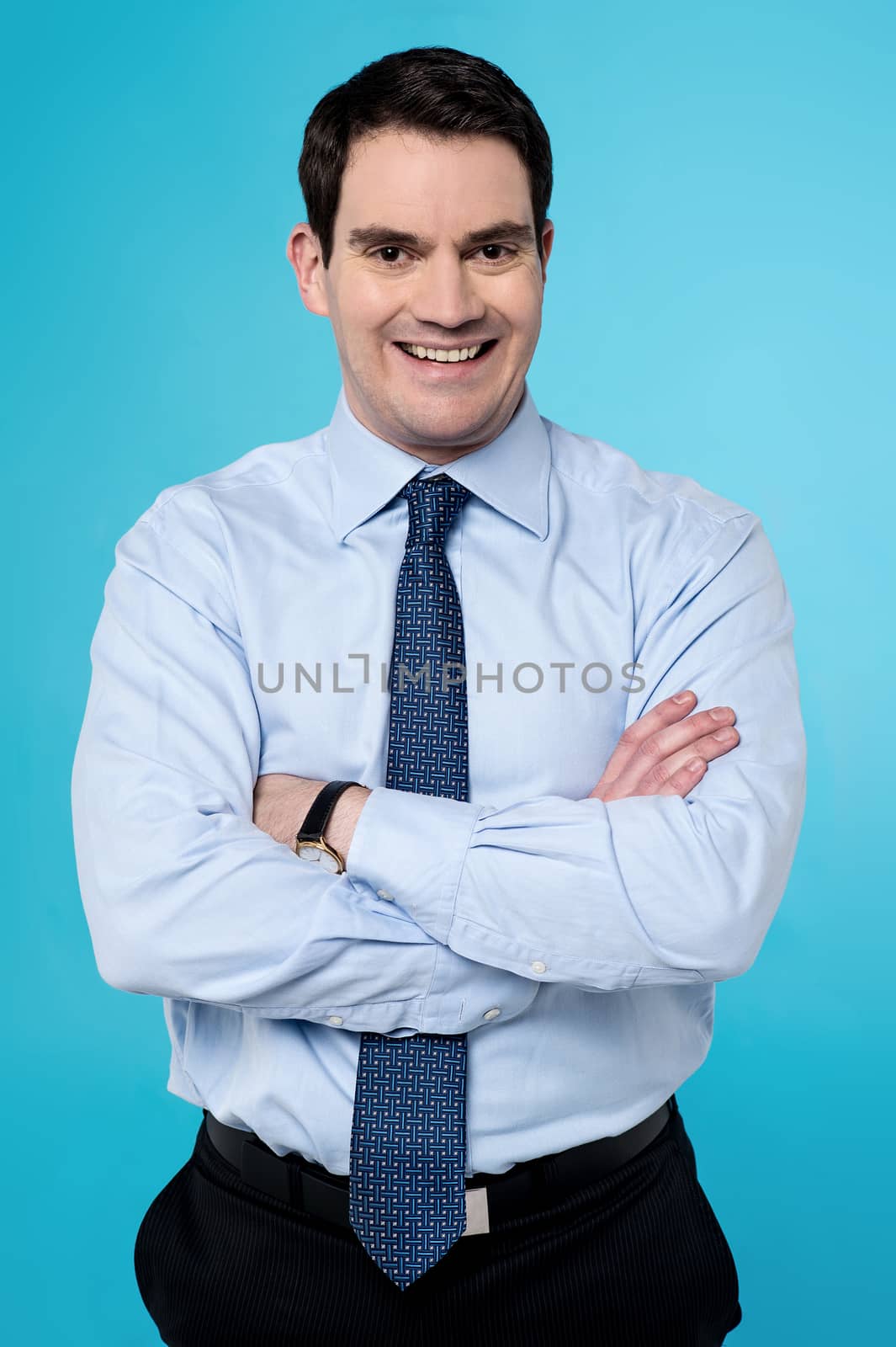 Image of a confident business executive with folded arms.