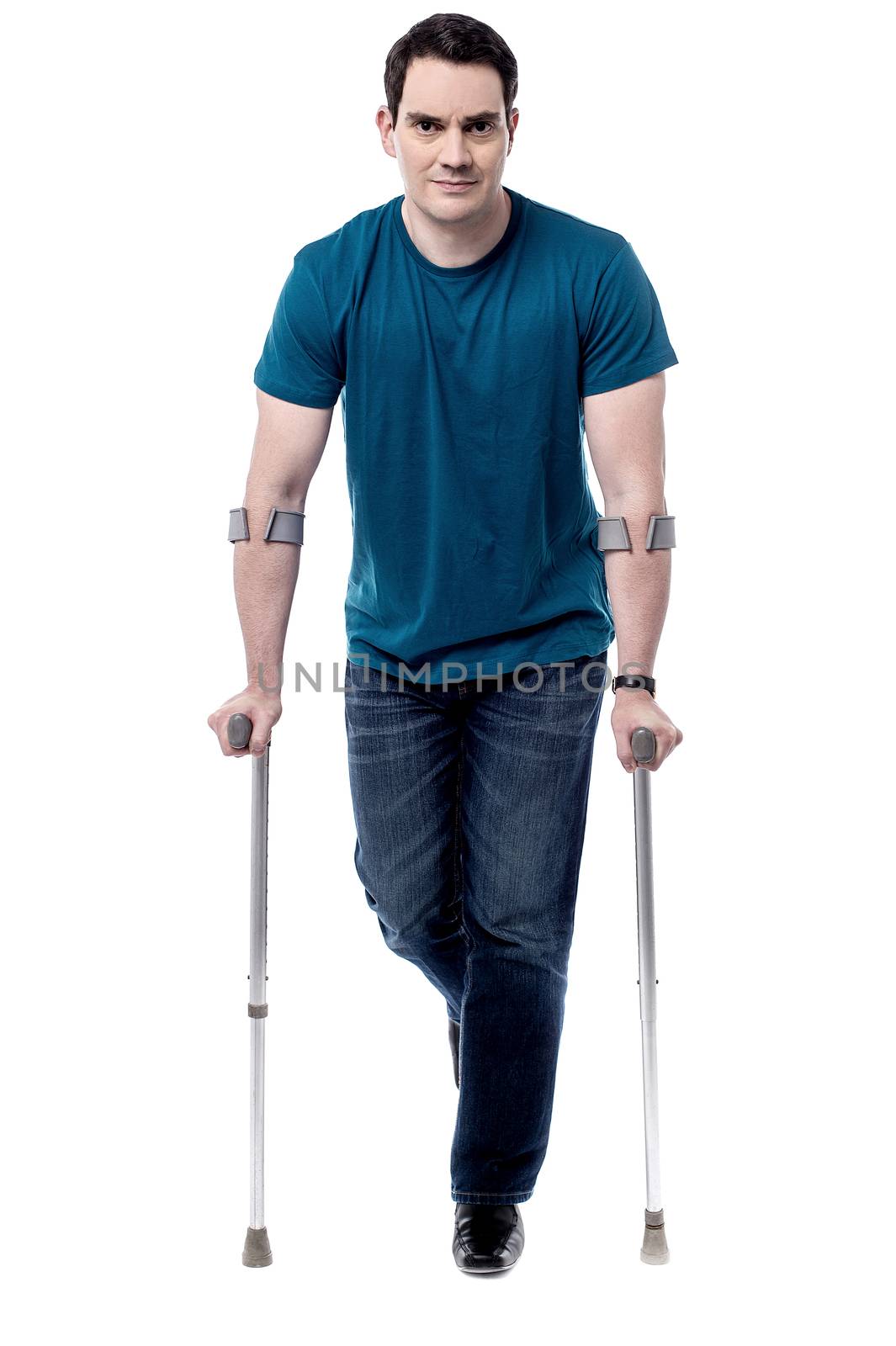 Full length of middle aged man walking with crutches
