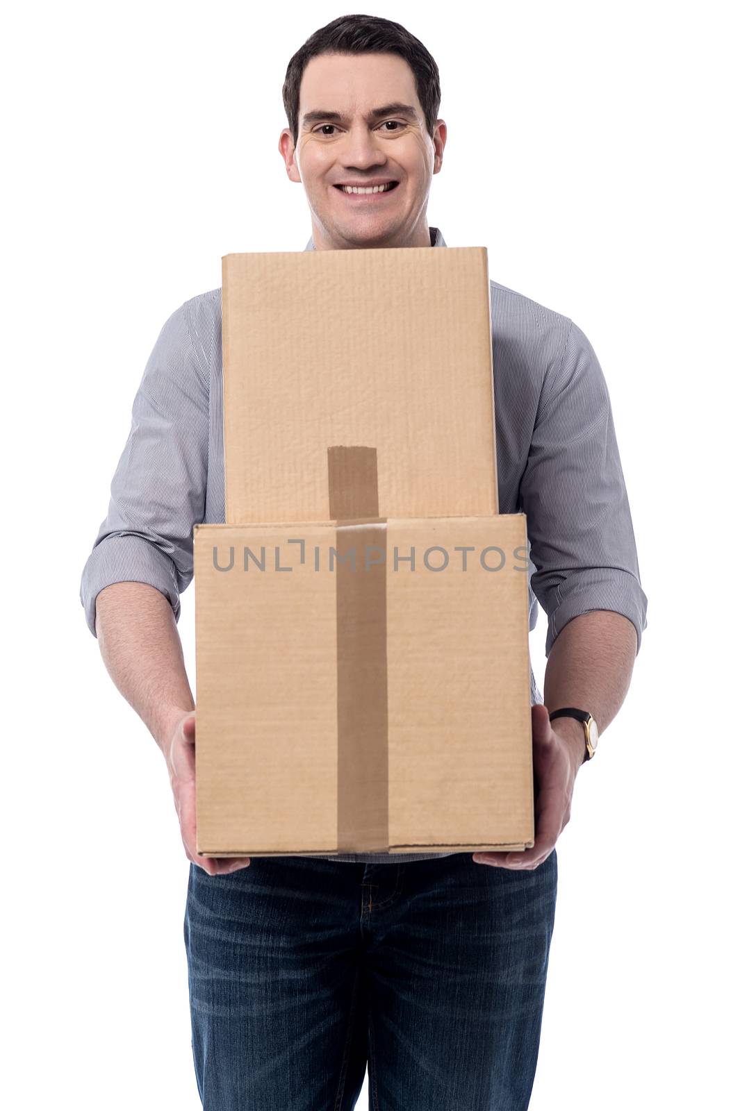 Happy middle aged man carrying stack of boxes