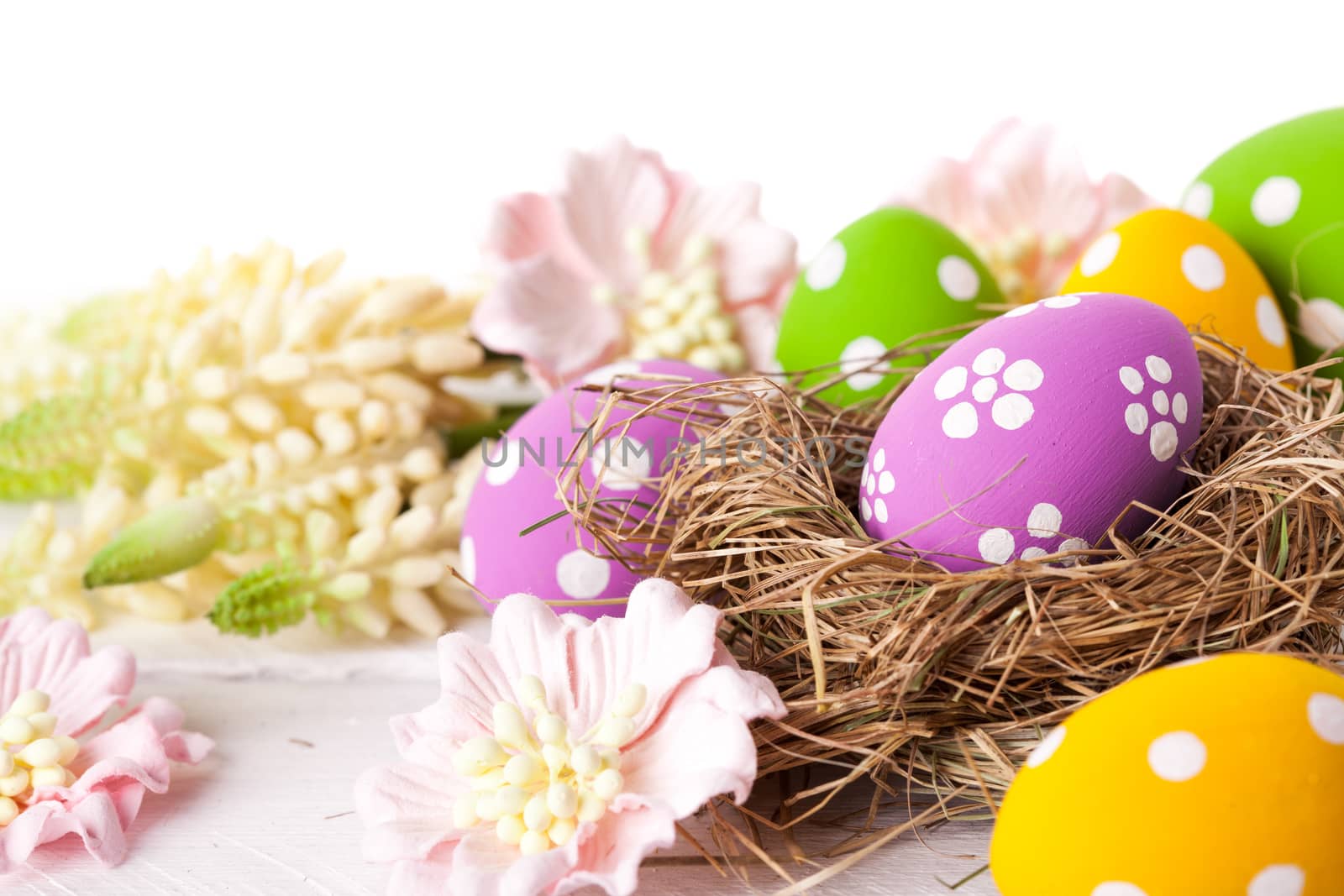 Easter nest dessert with decorative eggs. Studio shot