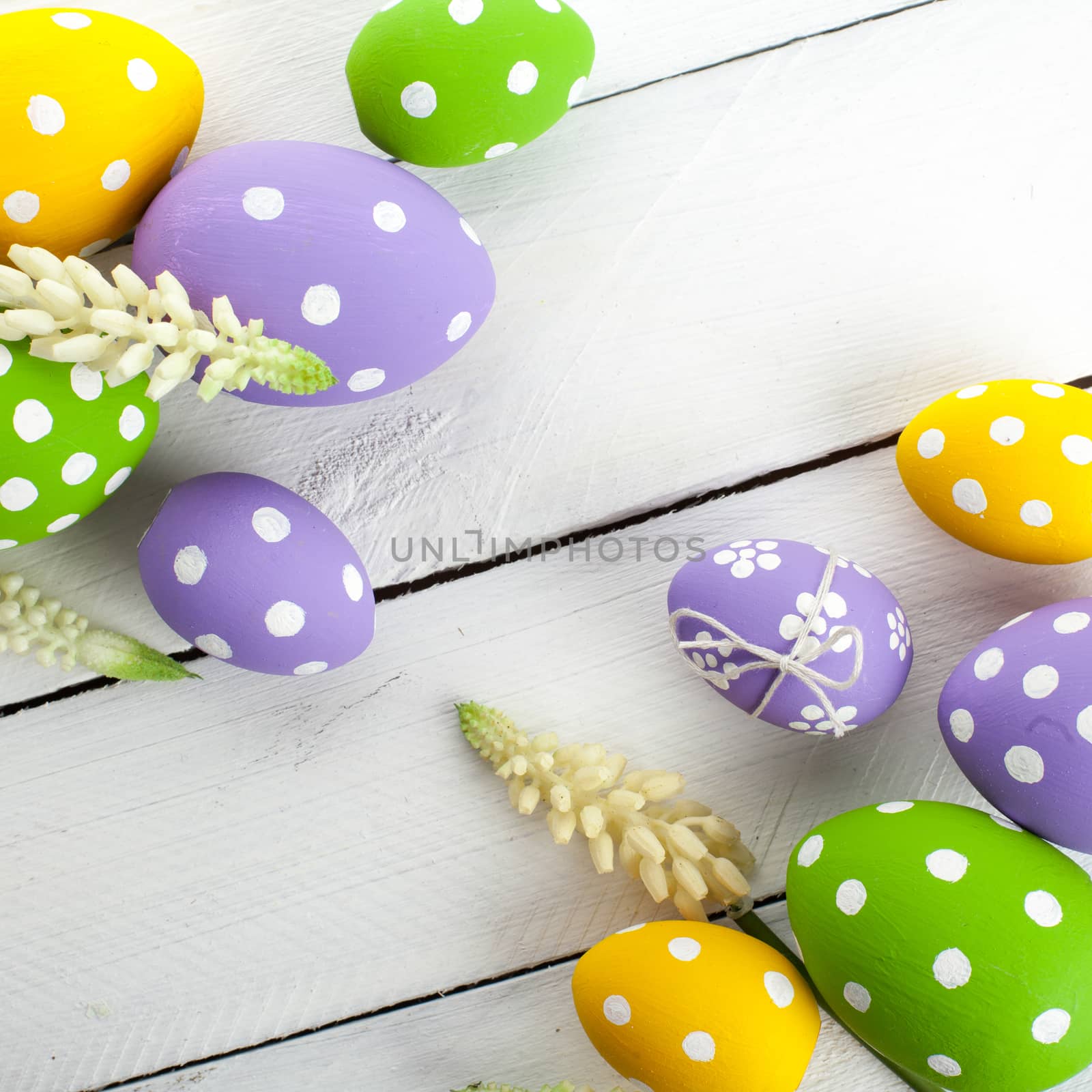 Easter background with colorful eggs over white wood