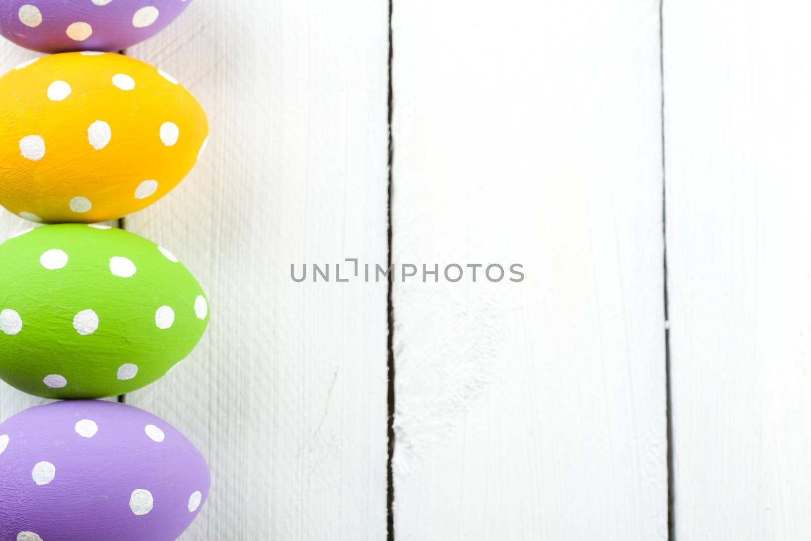 Colorful Easter Eggs on White or Gray Rustic Wood Background