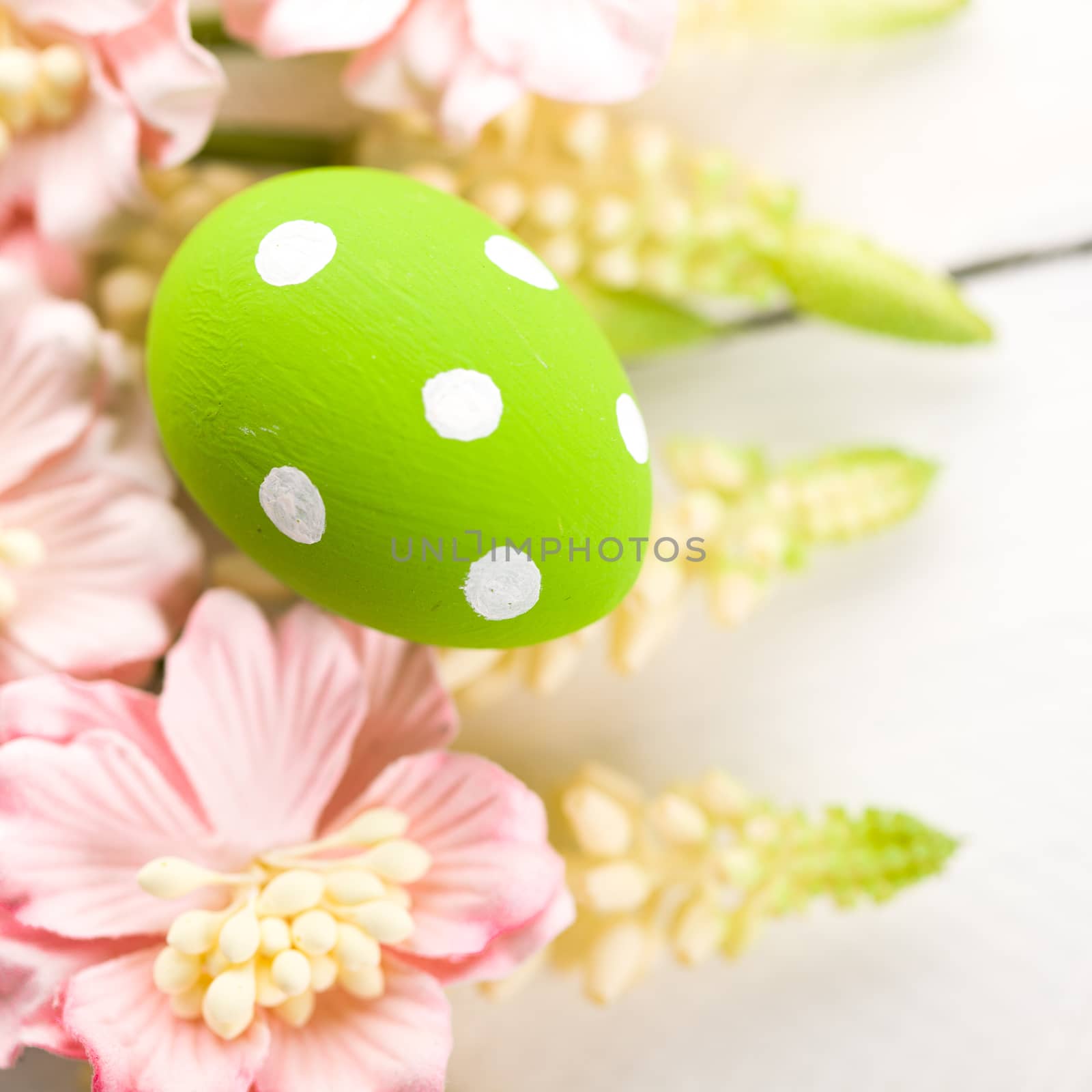 easter background with easter eggs and flowers on a old wooden table